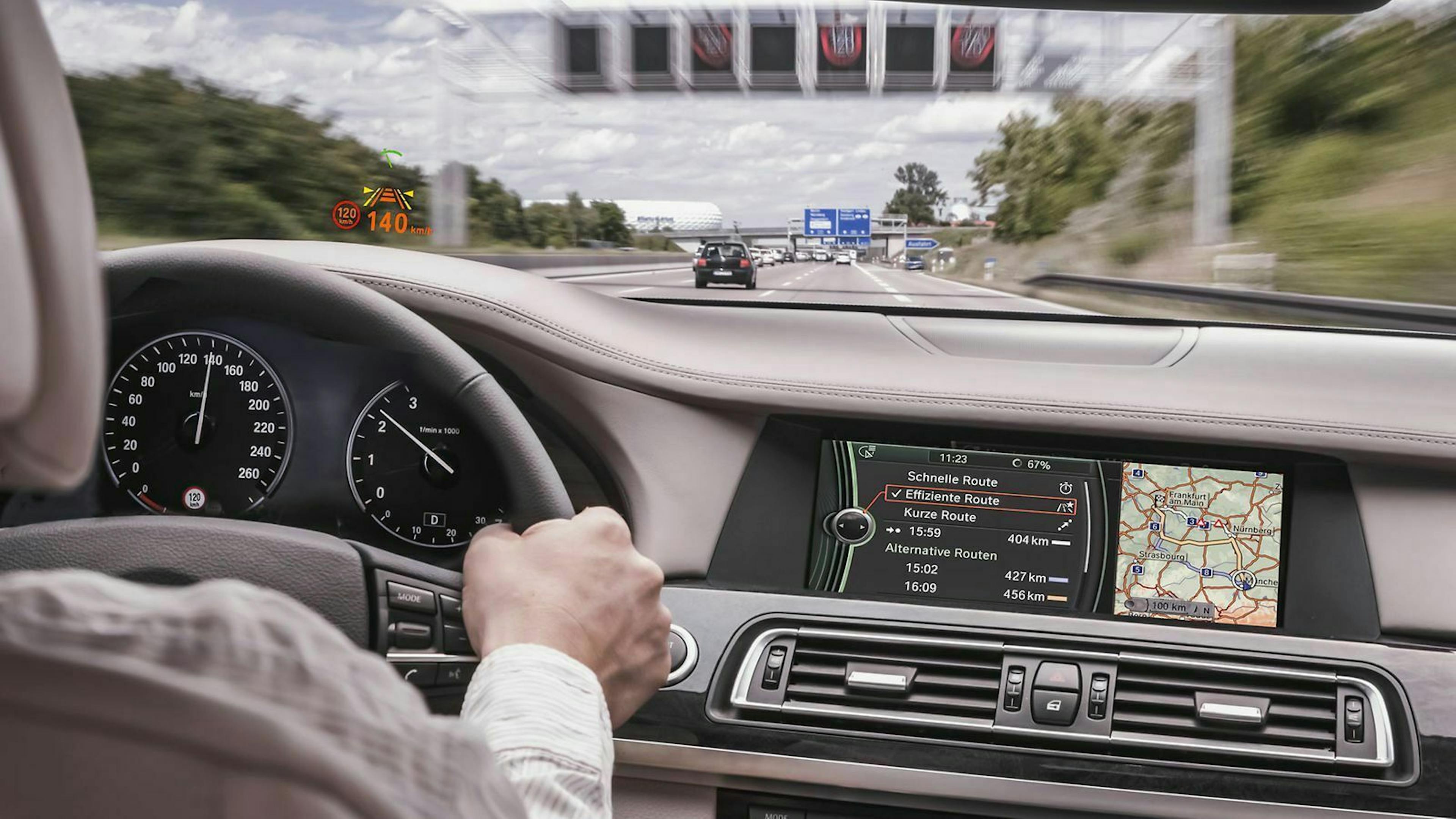 Jemand sitzt am Steuer eines PKW von BMW, dessen Tempokamera eine Höchstgeschwindigkeit von 120 km/h erkannt hat