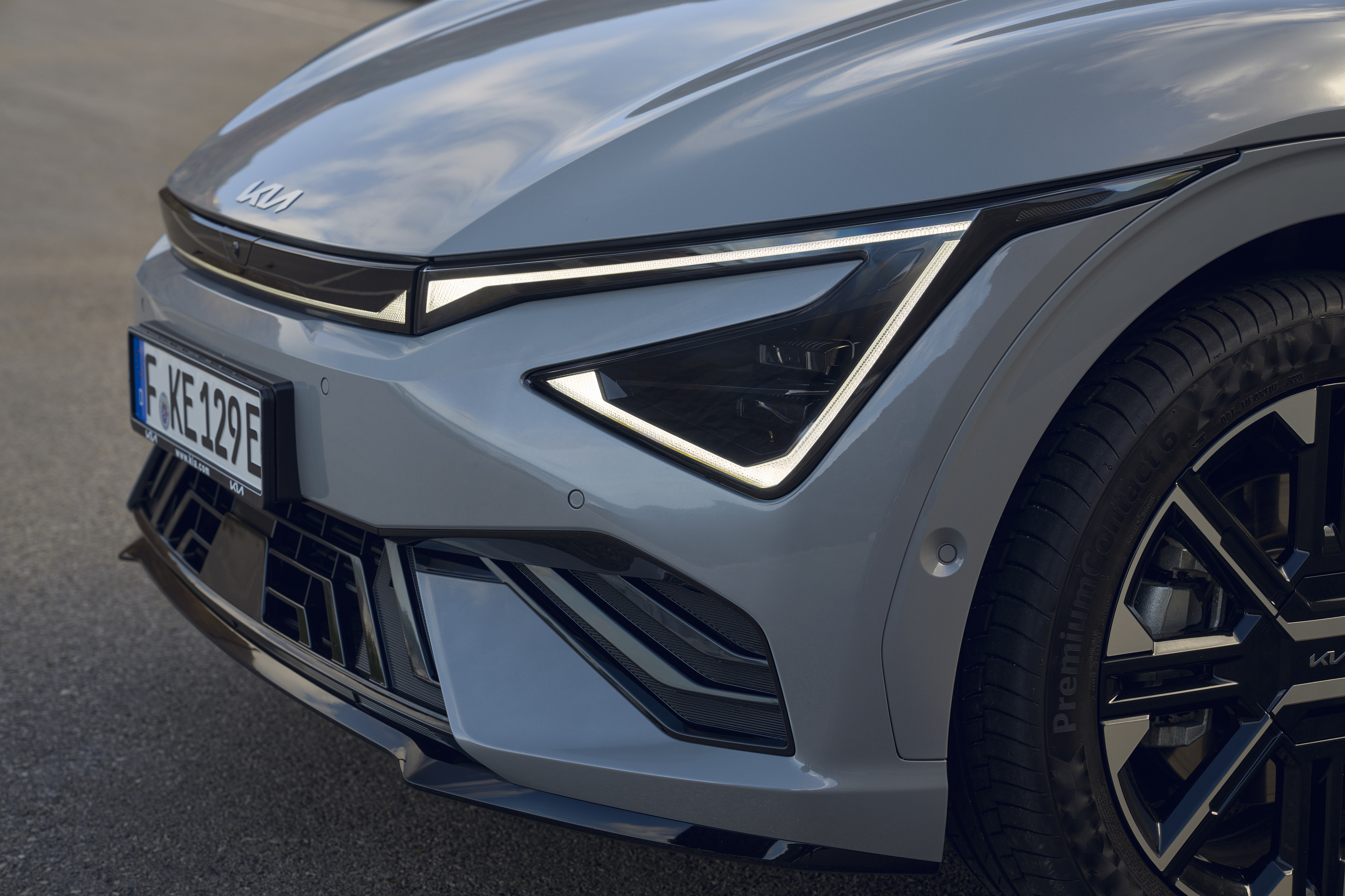  Standing Kia EV6 facelift. You can see the front end with the front lights in the side view.