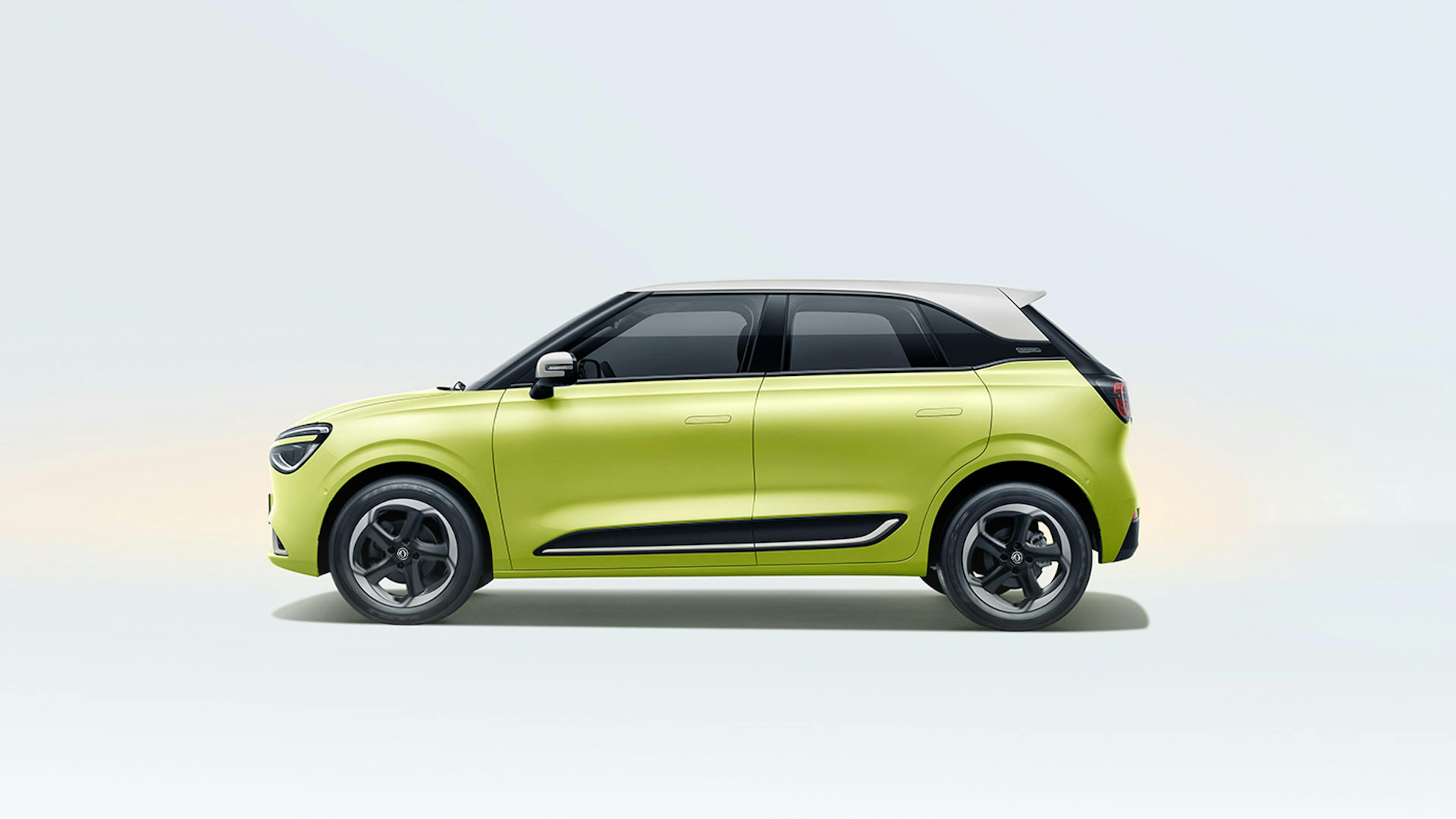 A yellow Dongfeng box stands on and in front of a white surface.