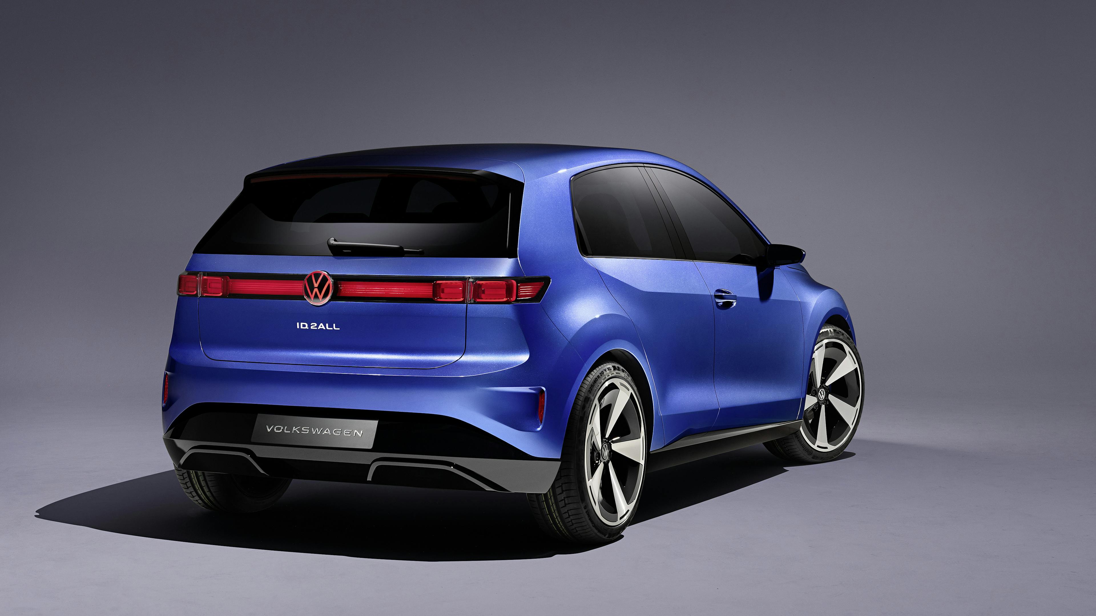 A blue VW ID.2 stands on a gray surface with the rear facing the viewer.