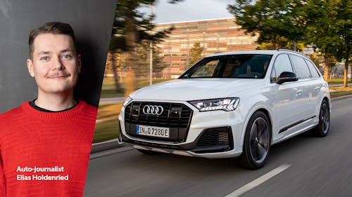 Der Redakteur und ein weißer Audi Q7, der durch die Stadt fährt.