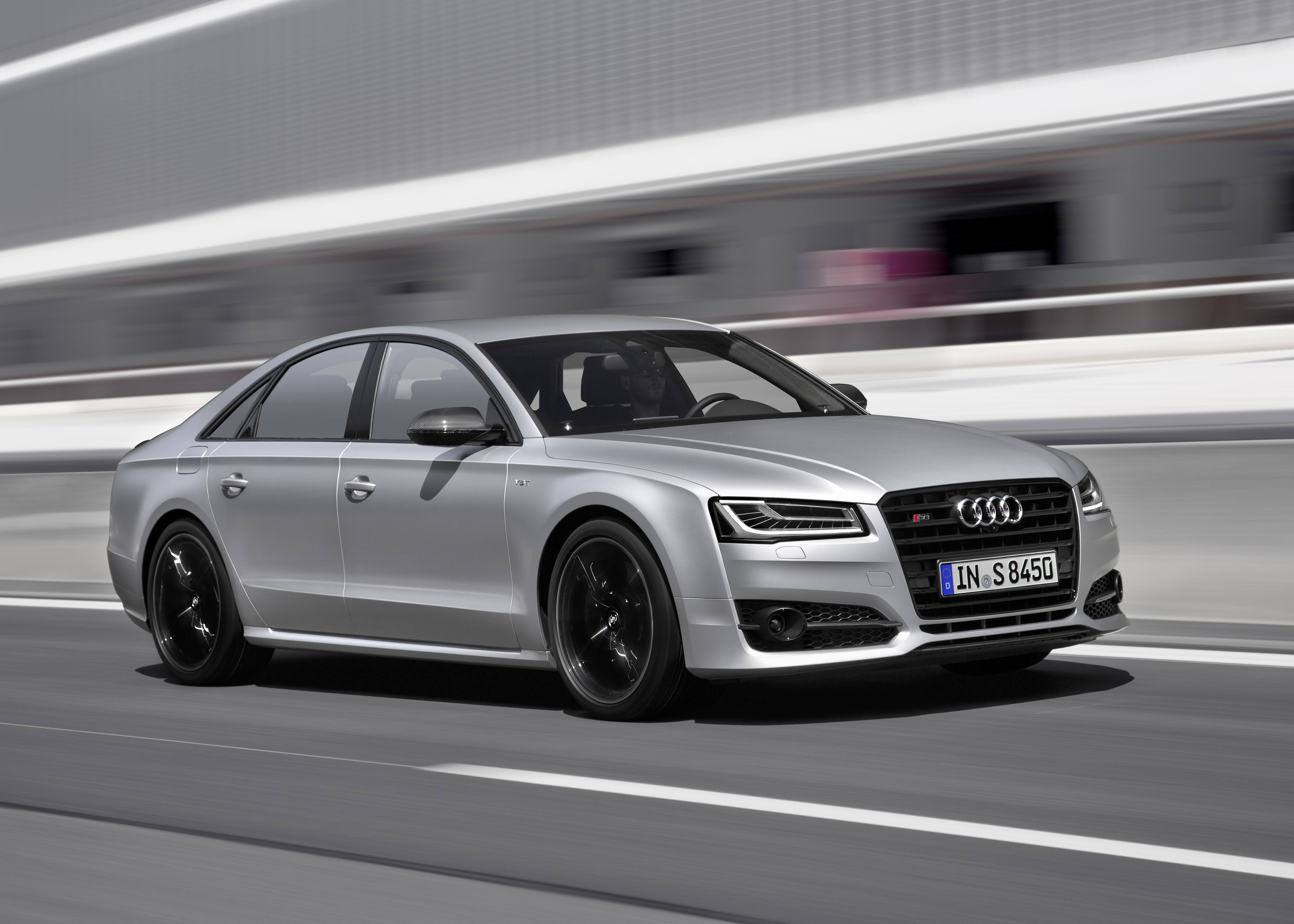 Ein silberner Audi S8 plus fährt auf einer Schnellstraße.