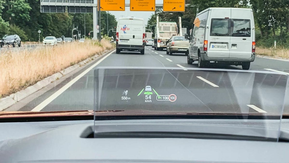 In der Frontscheibe eines Autos werden Fahr- und Navigationsdaten durch ein Head-up-Display angezeigt.