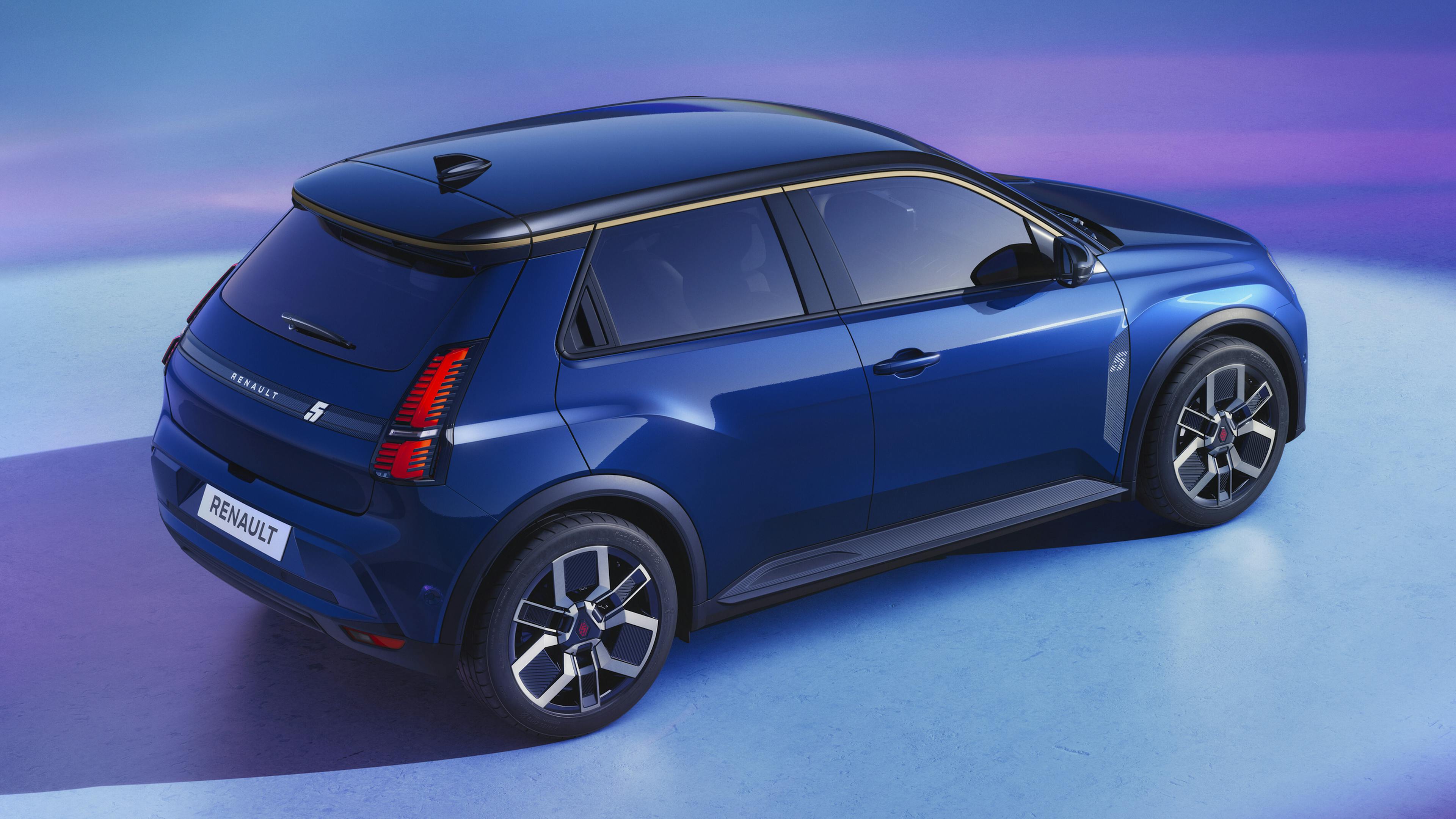 A blue Renault 5 E-Tech stands on a blue surface