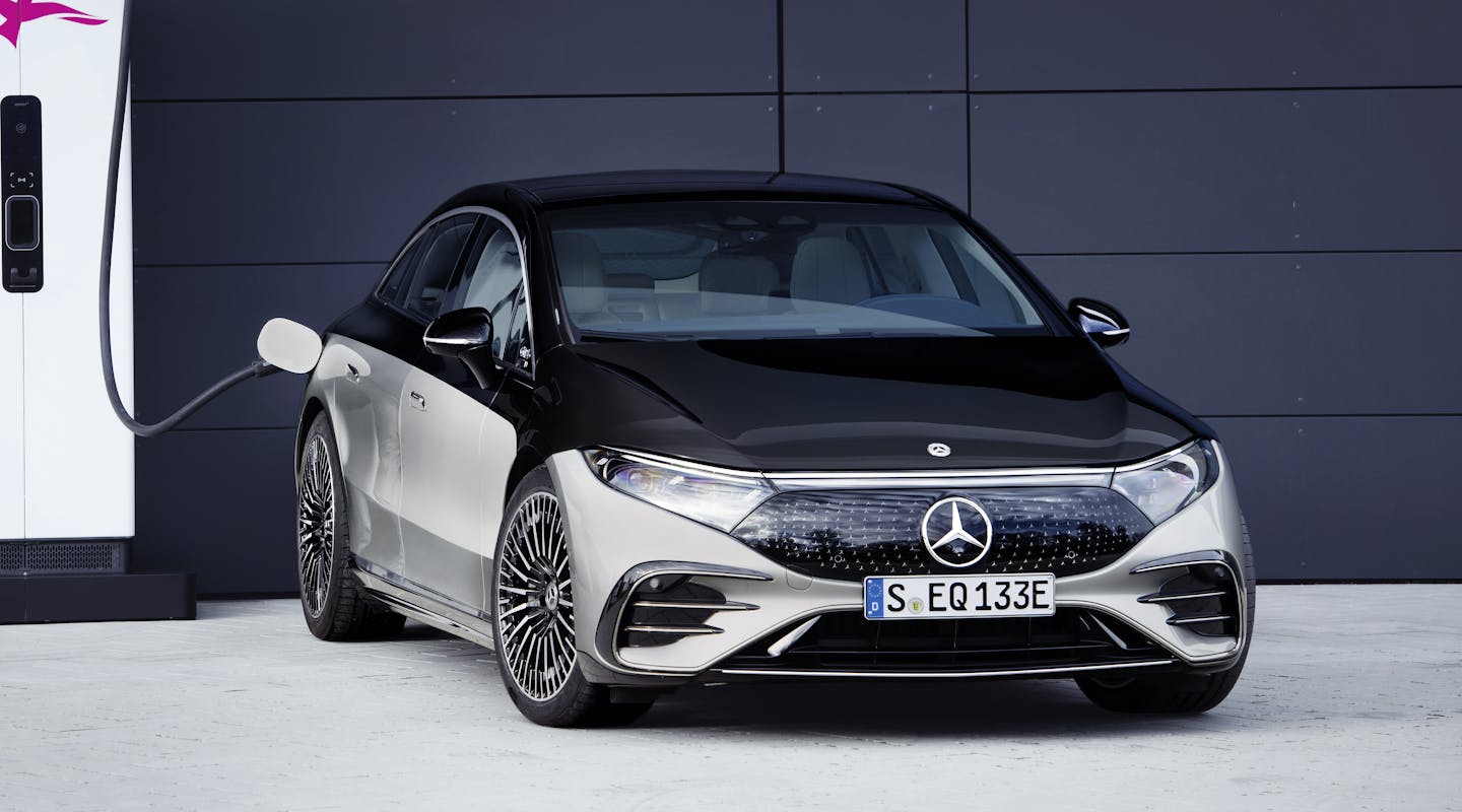 ein grau-schwarzer Mercedes-Benz EQS lädt an einer Ladesäule