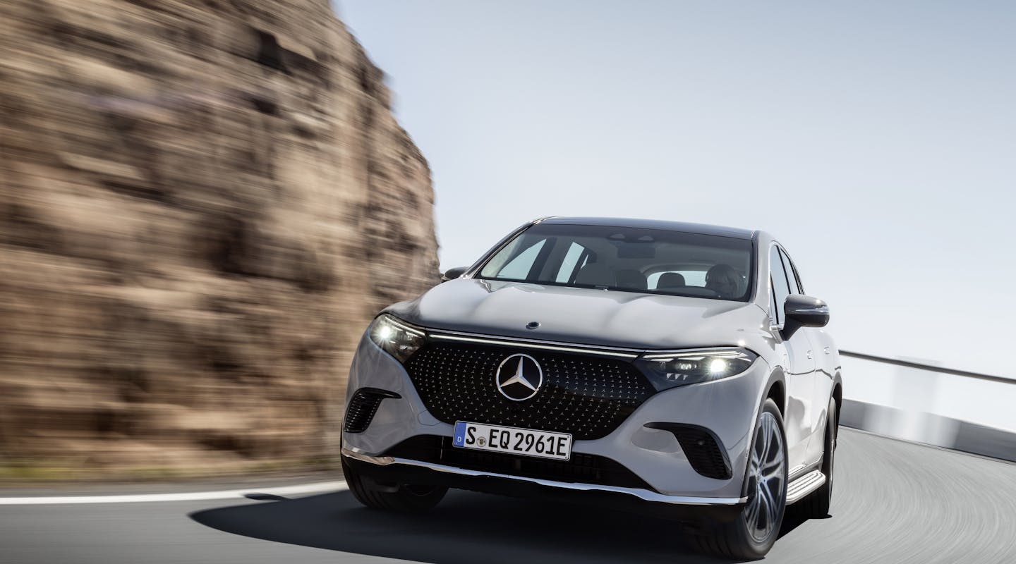 Ein weißer Mercedes-Benz EQS SUV fährt um eine Kurve