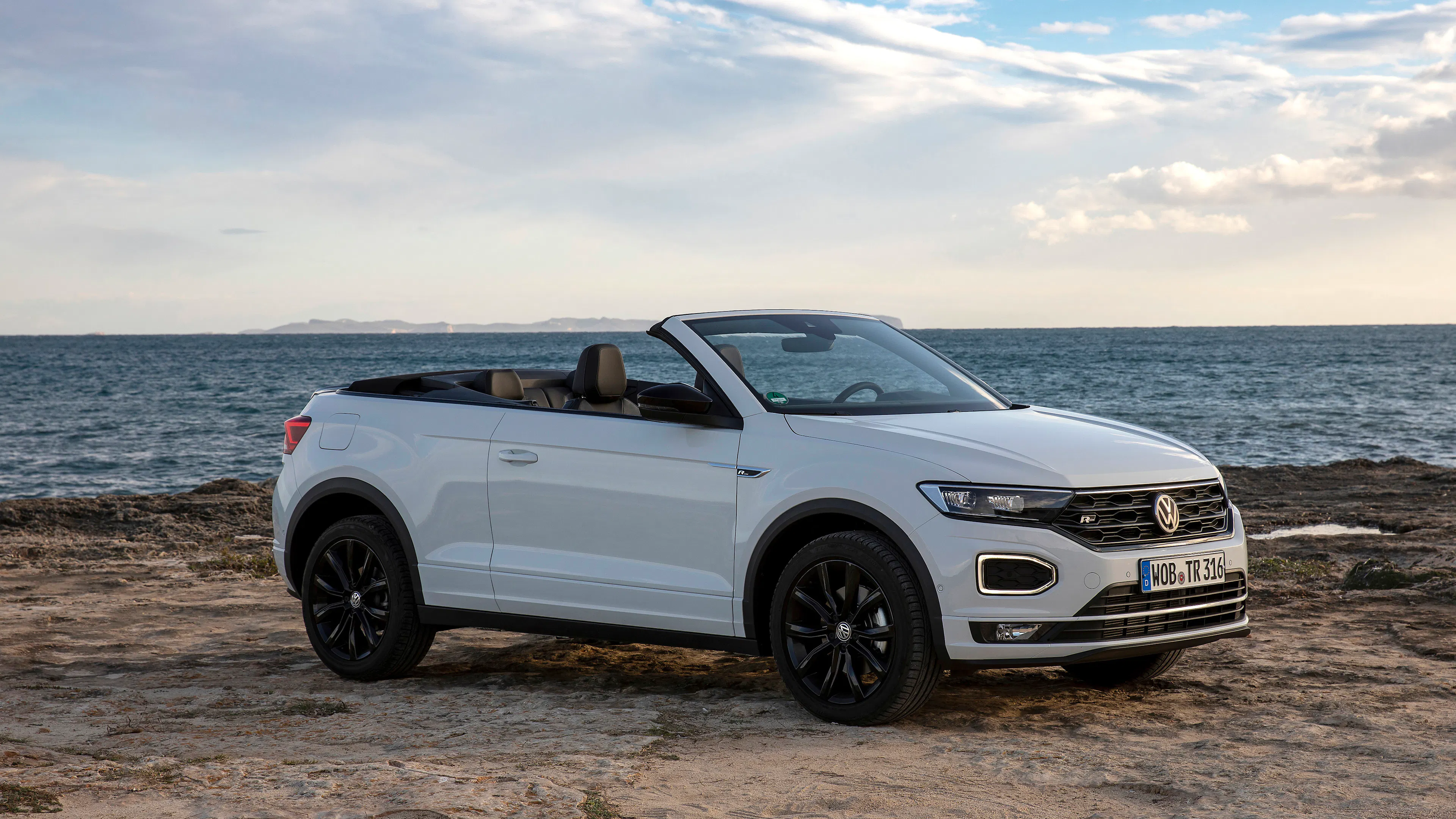 White VW T-Roc Cabriolet in side view, standing.