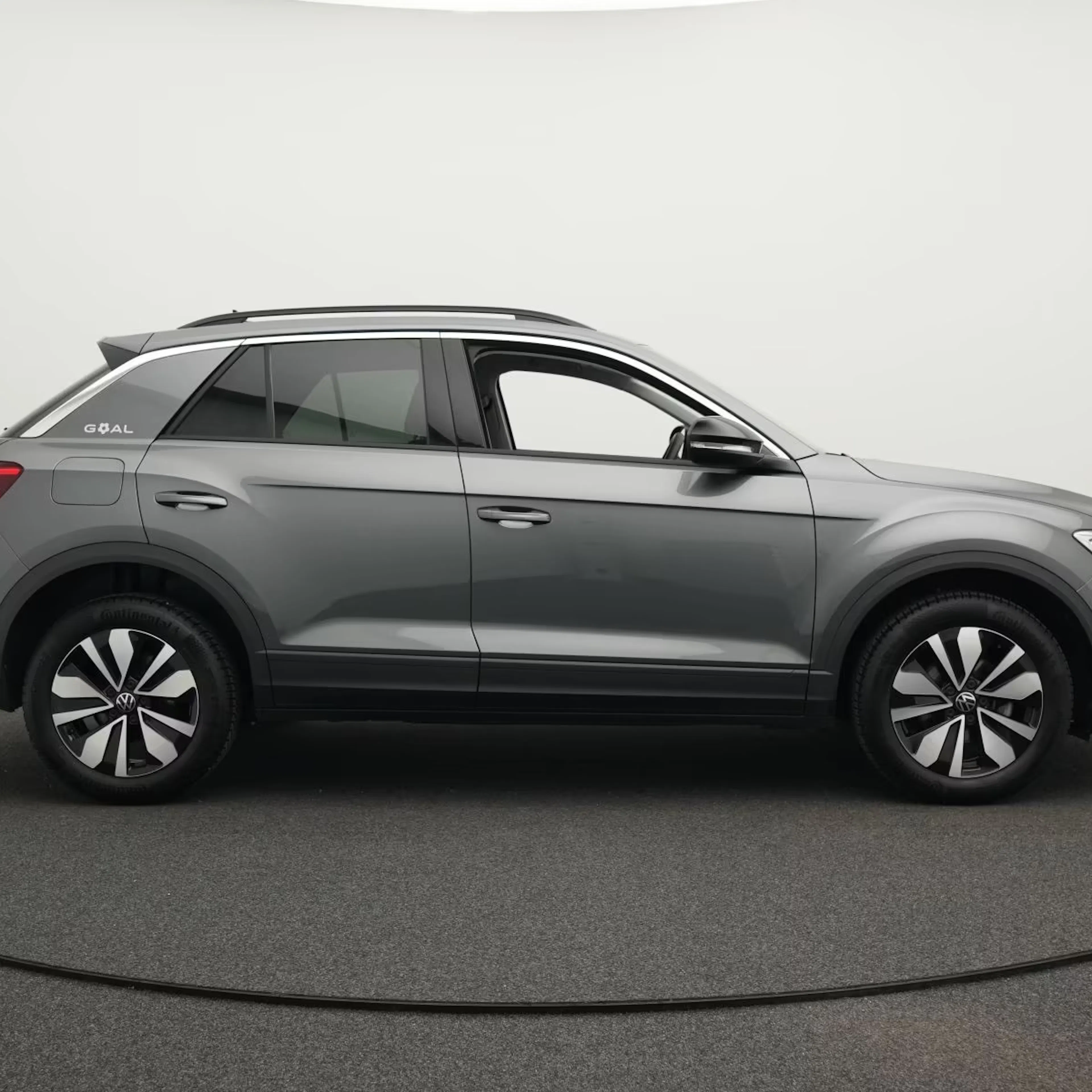 Ein grauer VW T-Roc steht auf einer Verkaufsfläche.