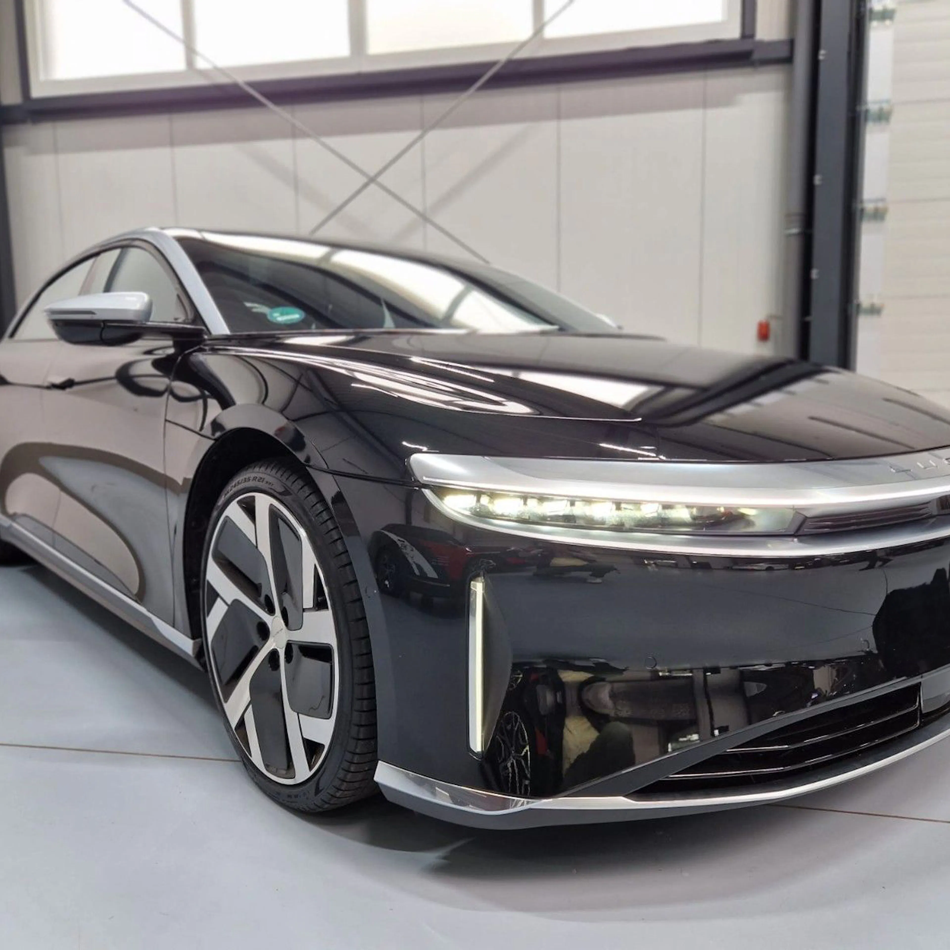 Ein schwarzer Lucid Air in einer Händlerhalle.