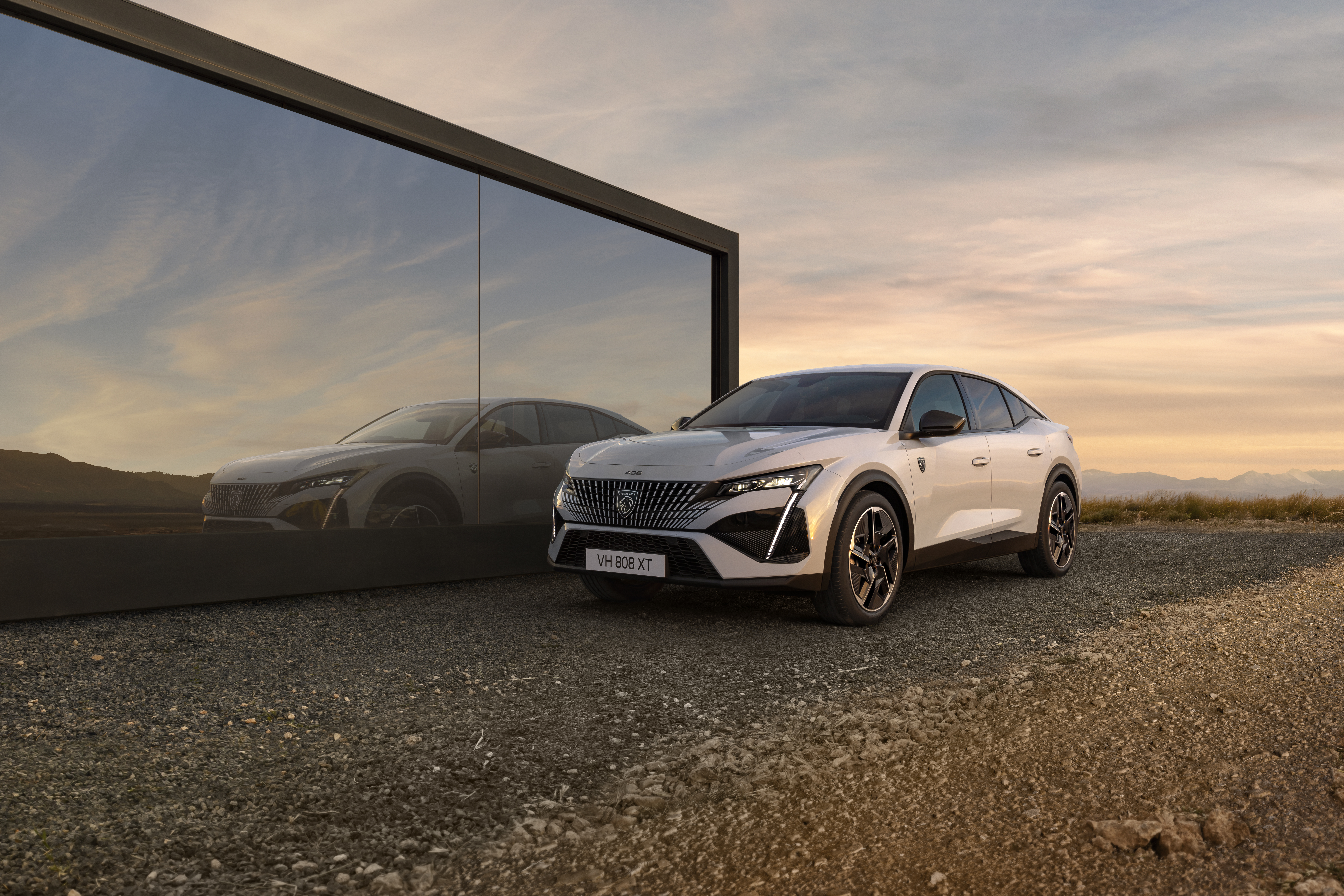 ein Peugeot e-408 parkt neben einem Haus