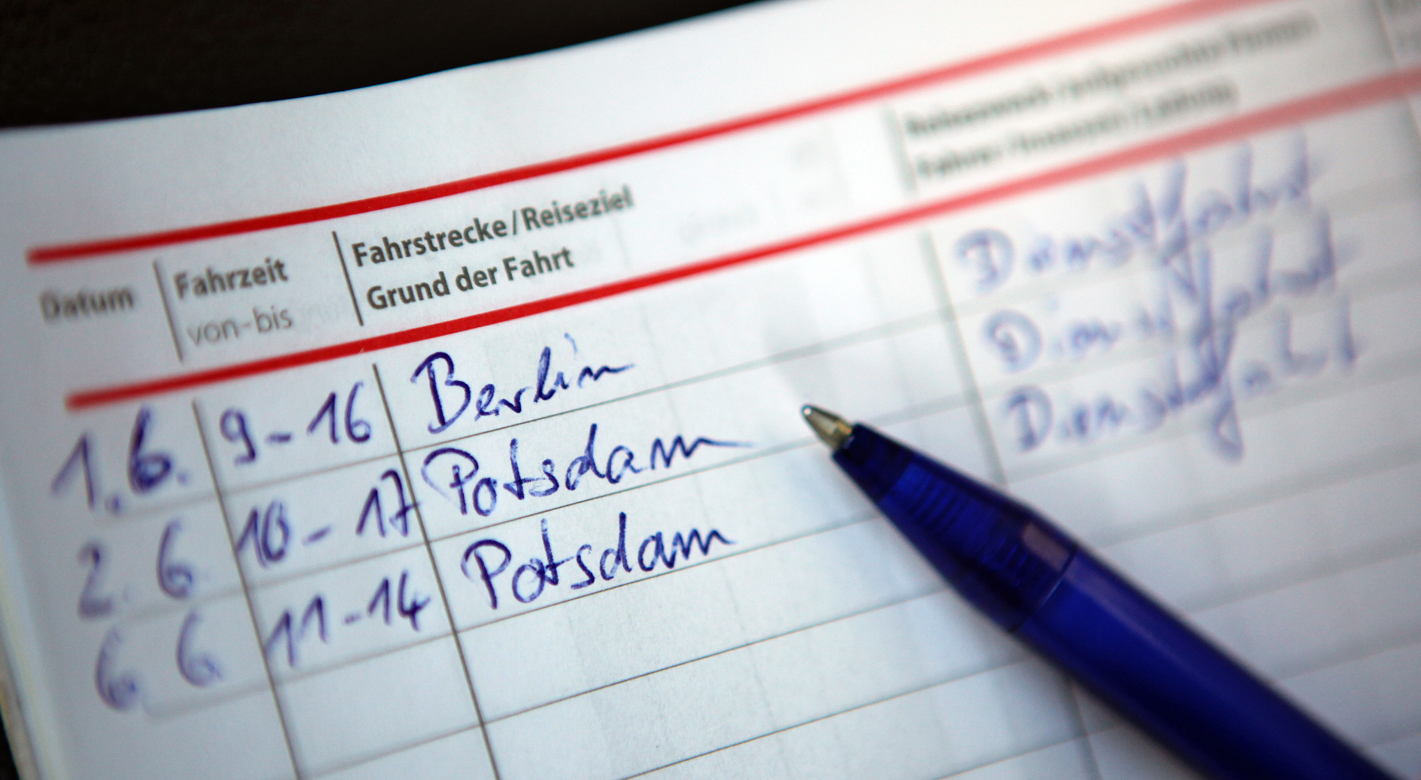 In einem aufgeschlagenen Fahrtenbuch sind mehrere Dienstfahrten eingetragen.