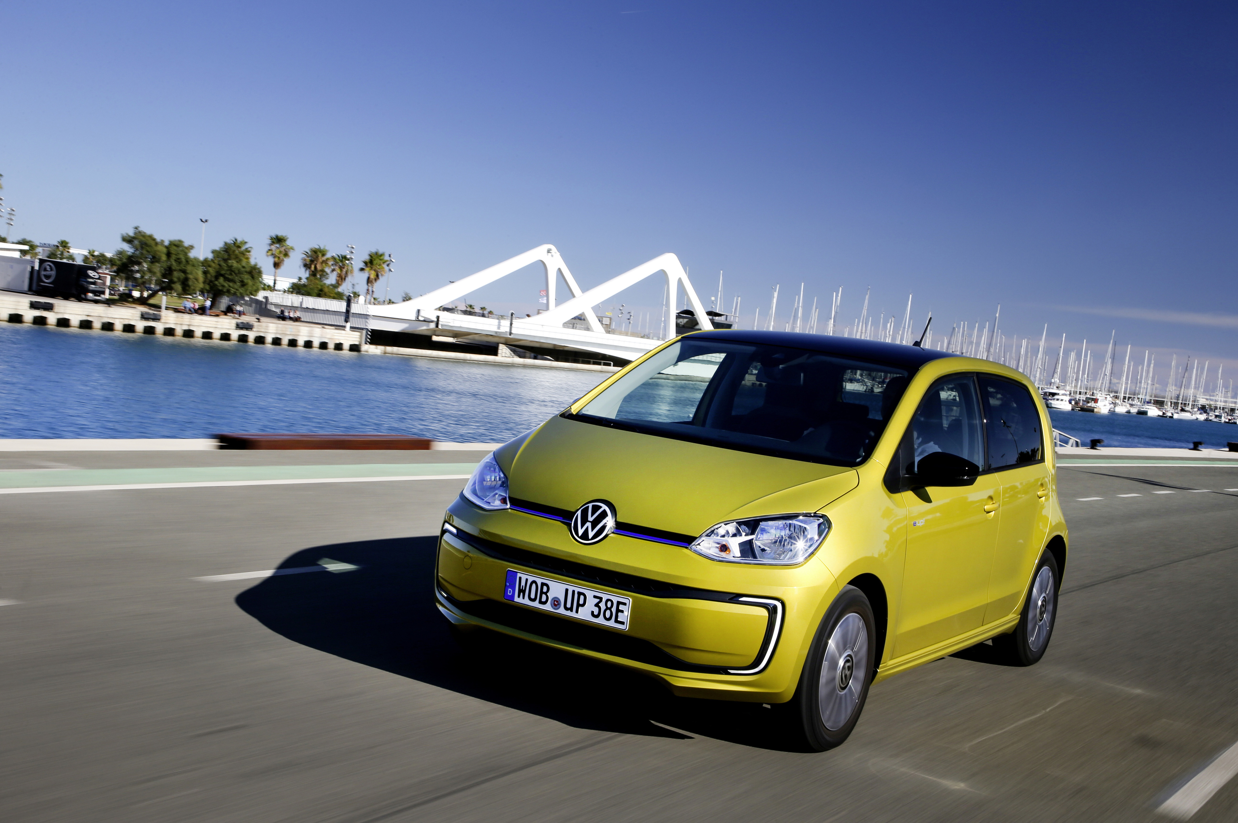 Ein gelber VW e-up! fährt auf einer Straße.