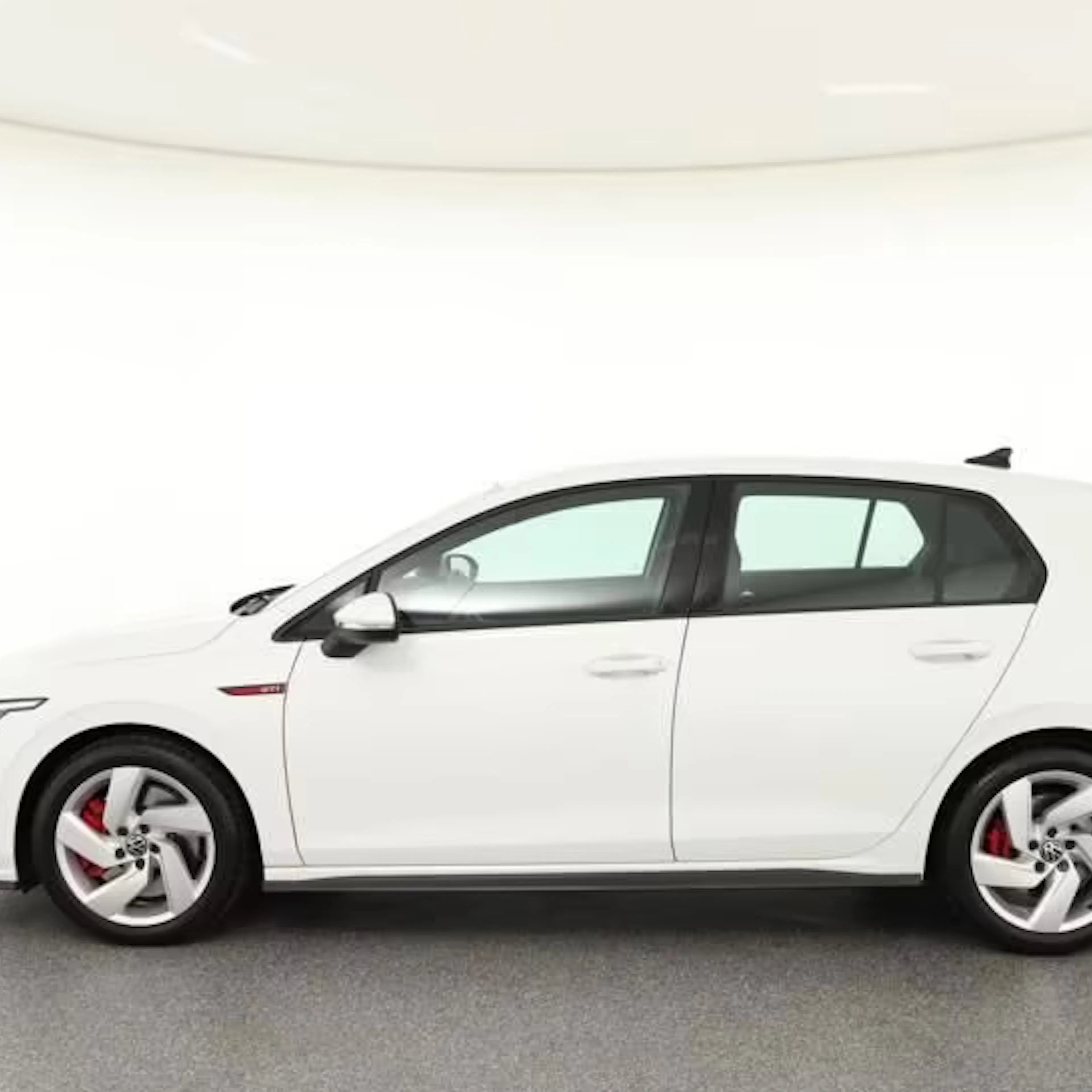 Ein weißer VW Golf steht auf einer Präsentationsfläche beim Händler.