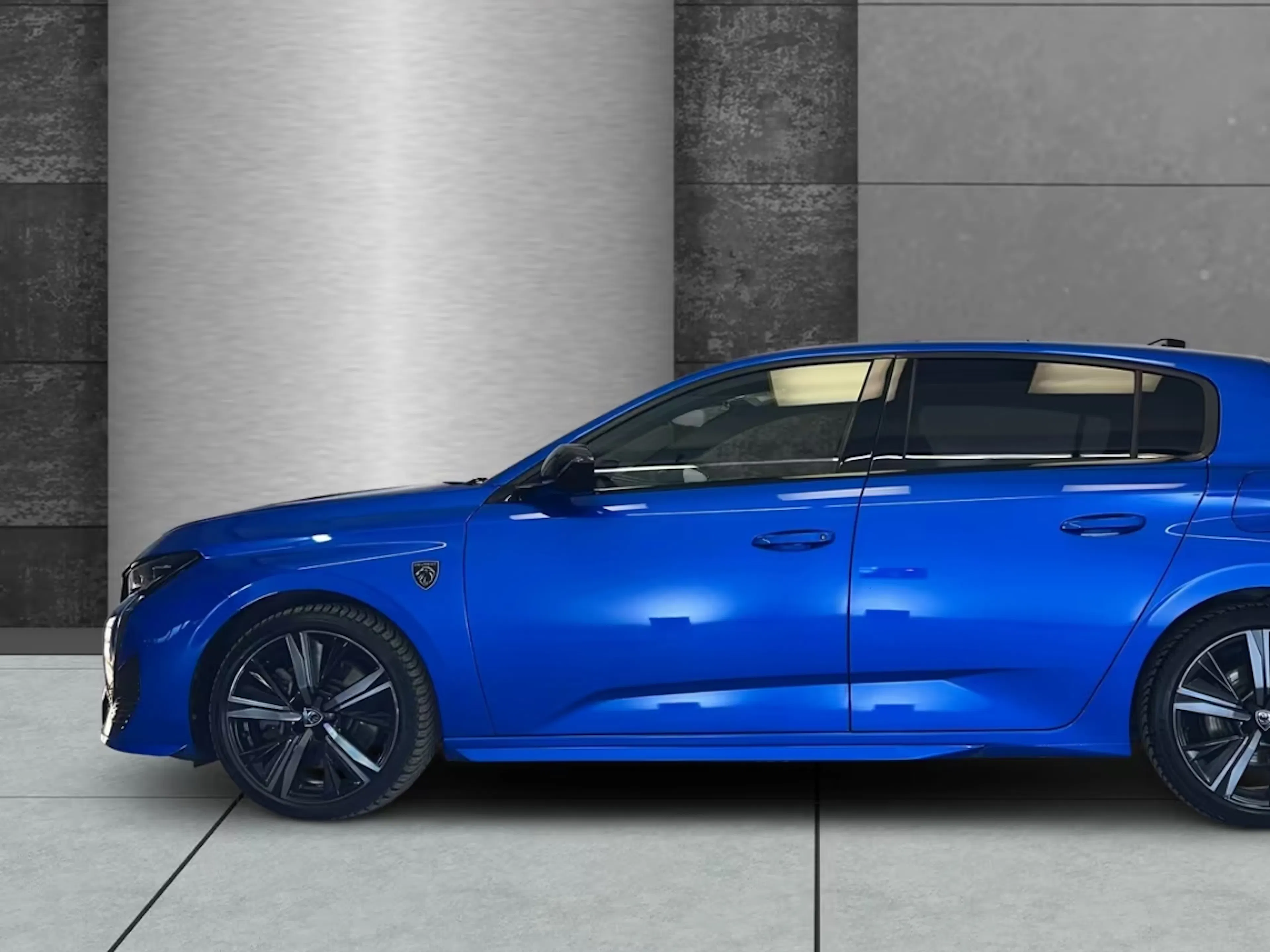 Ein blauer Peugeot 308 steht in einem Verkaufsraum.