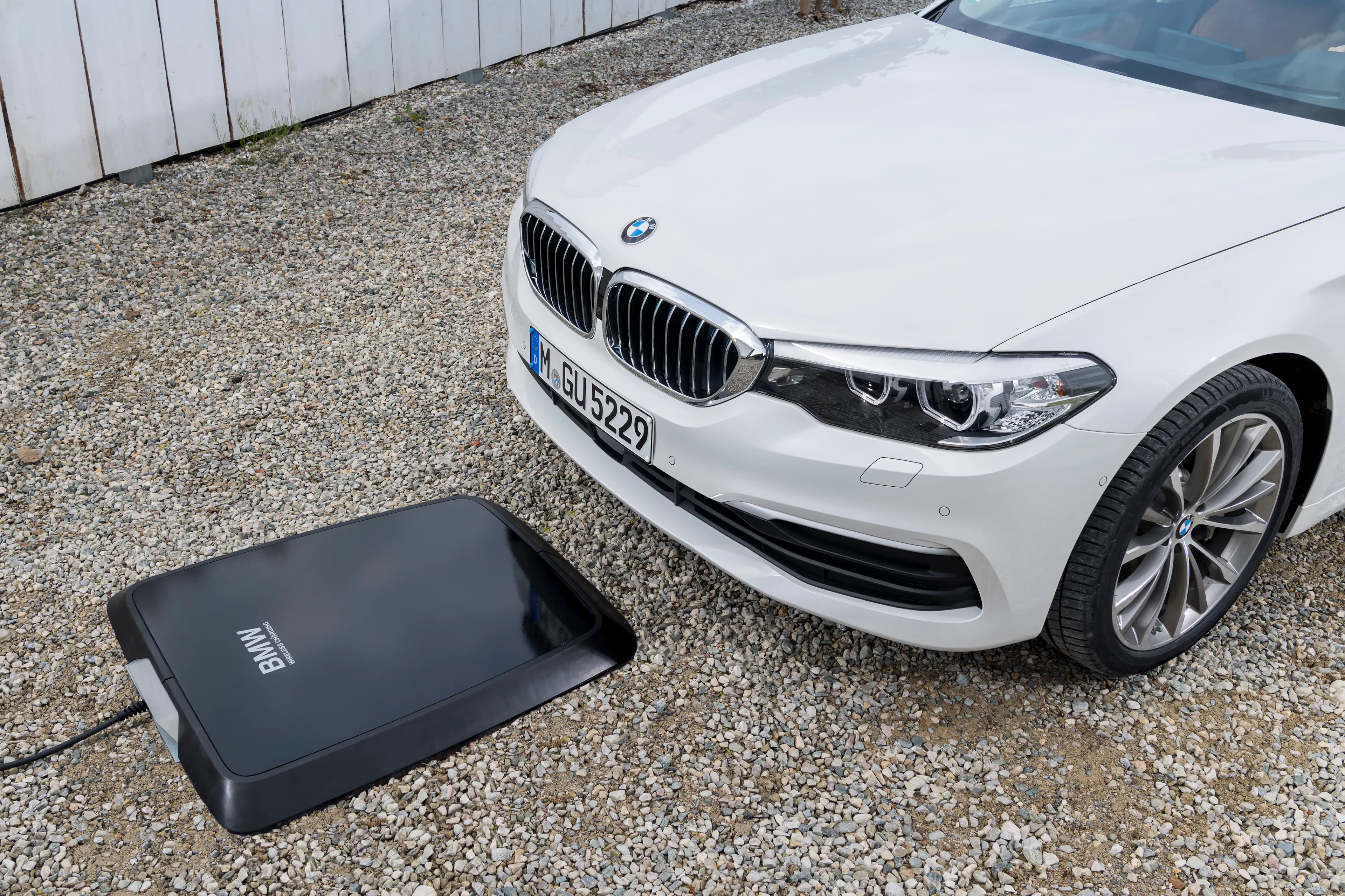 Weißer BMW beim induktiven Laden