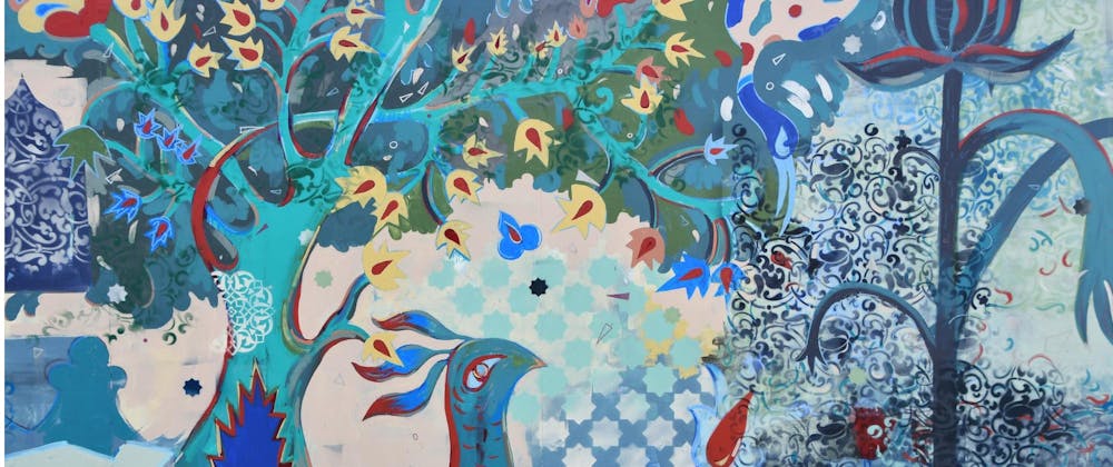 Detail of Reem Bassous' mural at Shangri La - a painting that features a peacock in front of a turquoise tree with many yellow and red flowers. To the right of the tree is a giant dark blue flower. There are many star-shapes and floral patterns in the background.