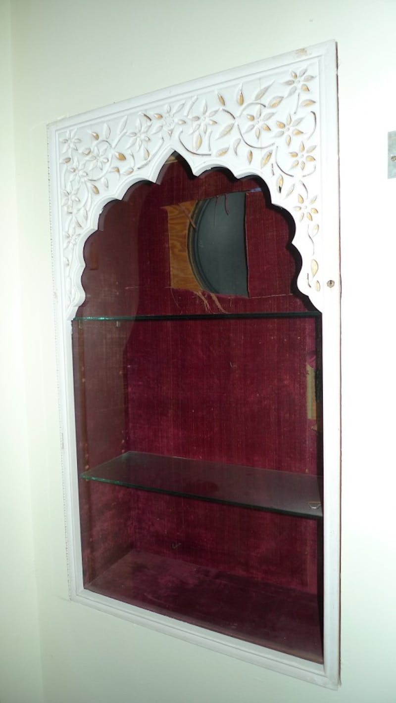 A piece of velvet is removed to further investigate the vitrine’s original construction.