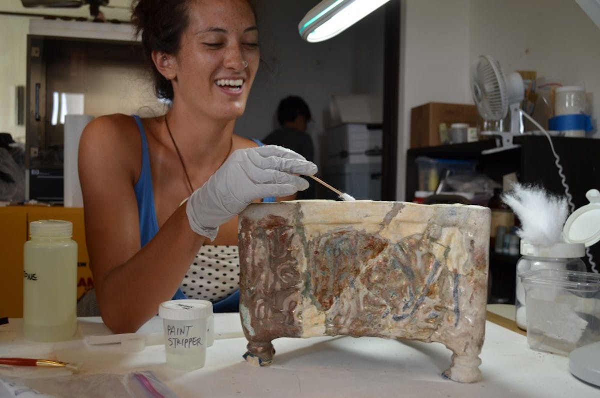 Kat Harada removes overpaint from a 12th–13th-century tabouret, revealing previous restorations and repairs. Doris Duke Foundation for Islamic Art, Honolulu, Hawai‘i.