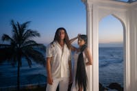 Photo of Asadi and Xye at Shangri La with sunset in background with ocean and palm trees.