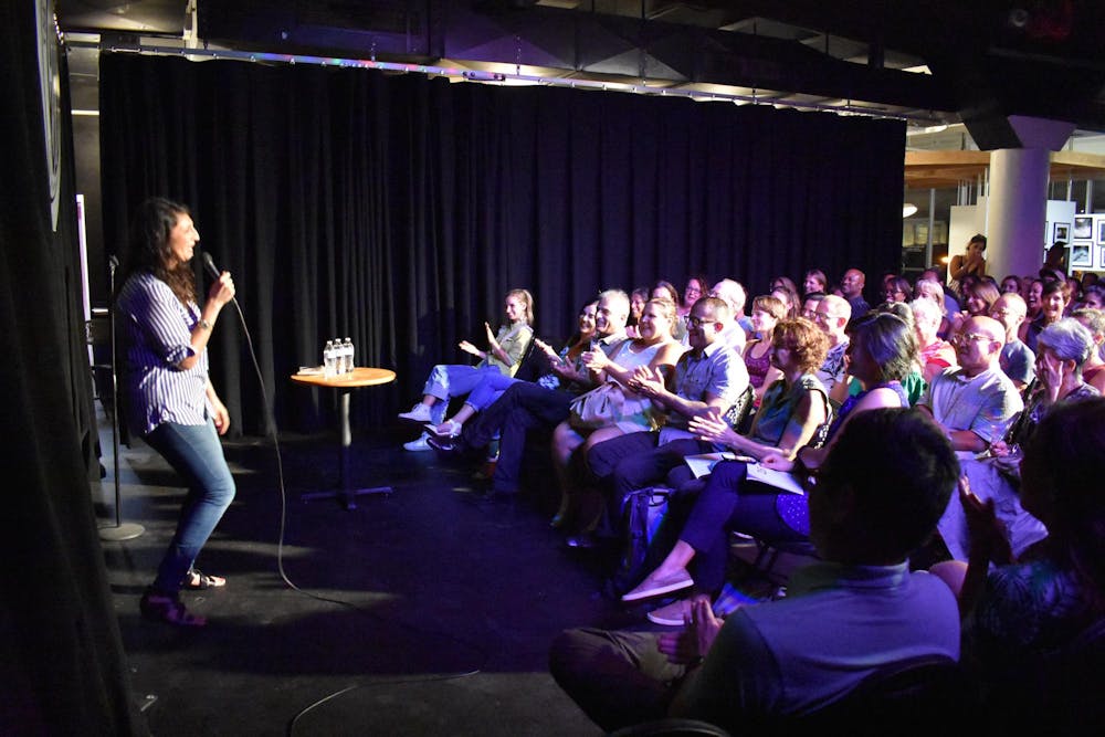 Zahra Noorbaksh performing stand-up comedy in front of an audience.