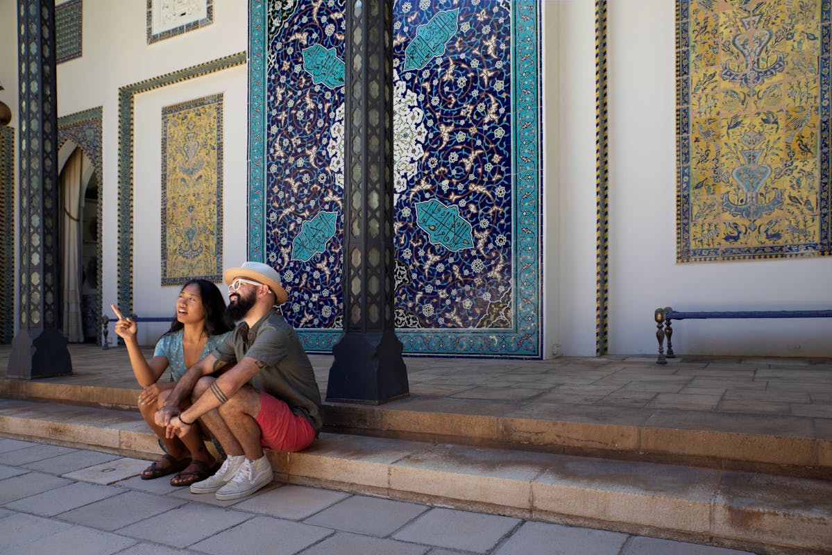 Photograph of Shangri La museum visitors exploring the central courtyard pointing at artwork and having a conversation.