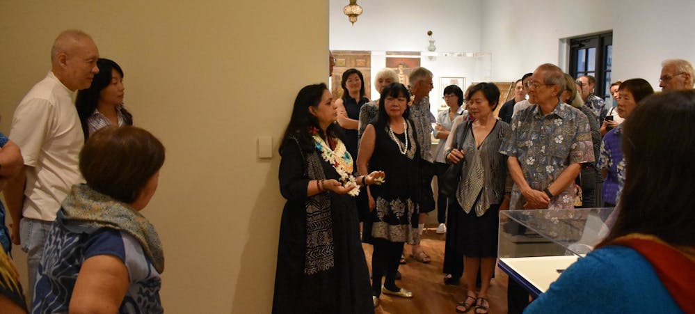 Noorjehan Bilgrami talking to guests during the opening for her exhibition, Under the Molsri Tree, at the Honolulu Museum of Art. 