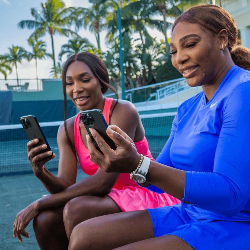 Serena and Venus Williams tenant un téléphone
