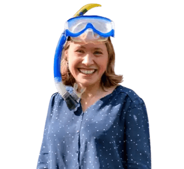 Rafaelle, smiling widely with a snorkel on her, the diving mask on top of her forehead.