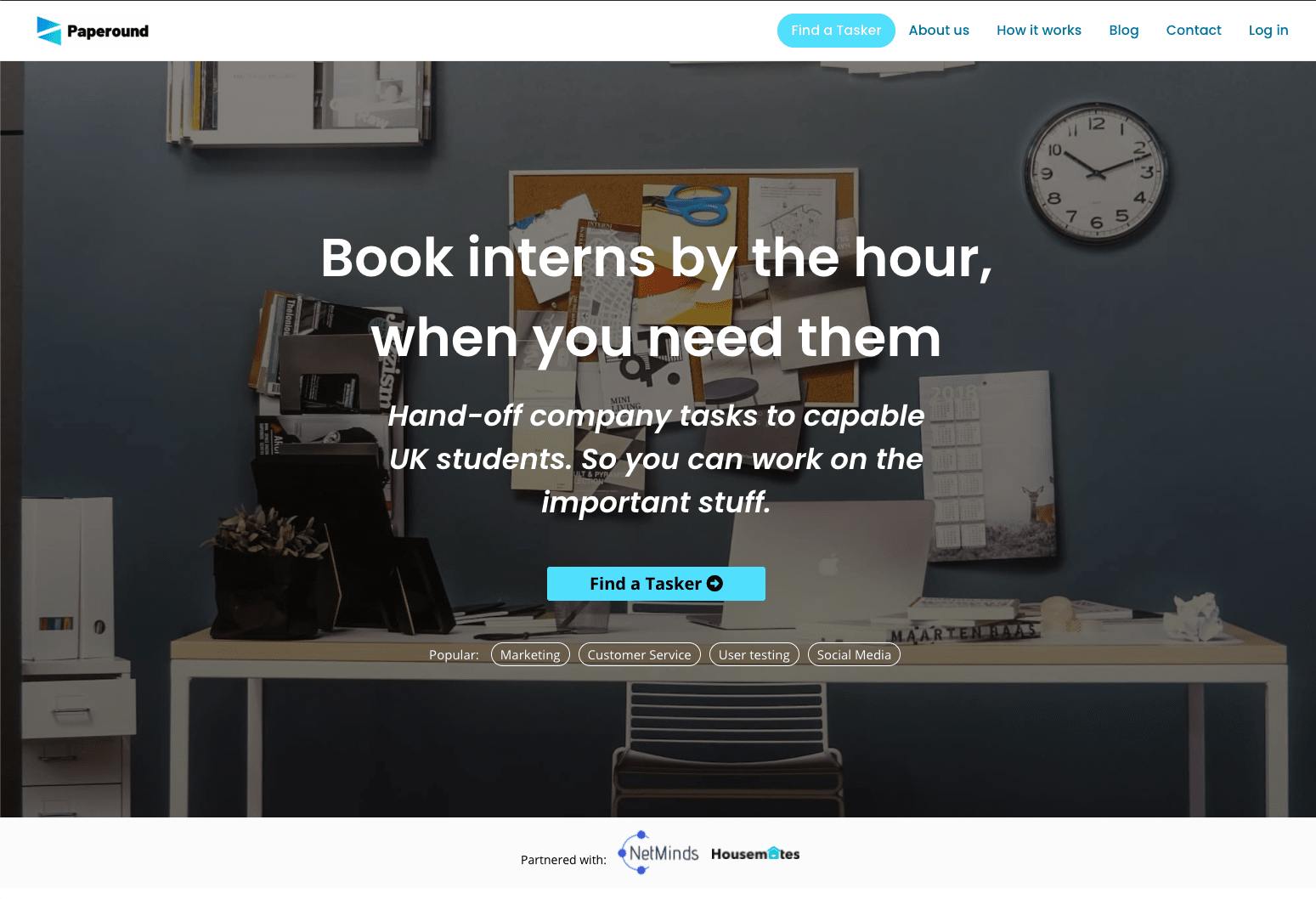 Screenshot of the service marketplace Paperound's landing page header featuring an office desk.