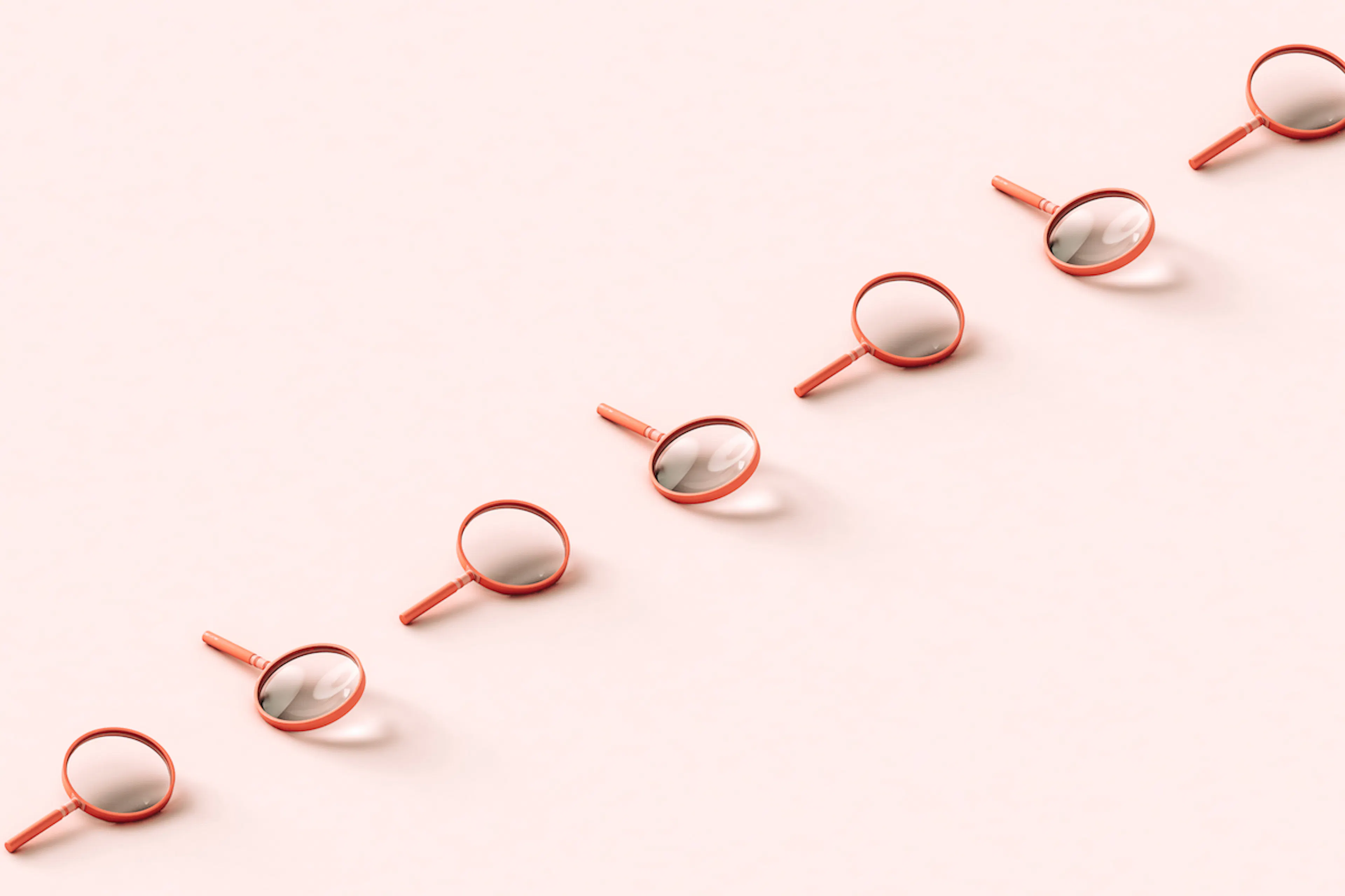 A row of pink 3D magnifying glasses crossing the frame on pale pink background.