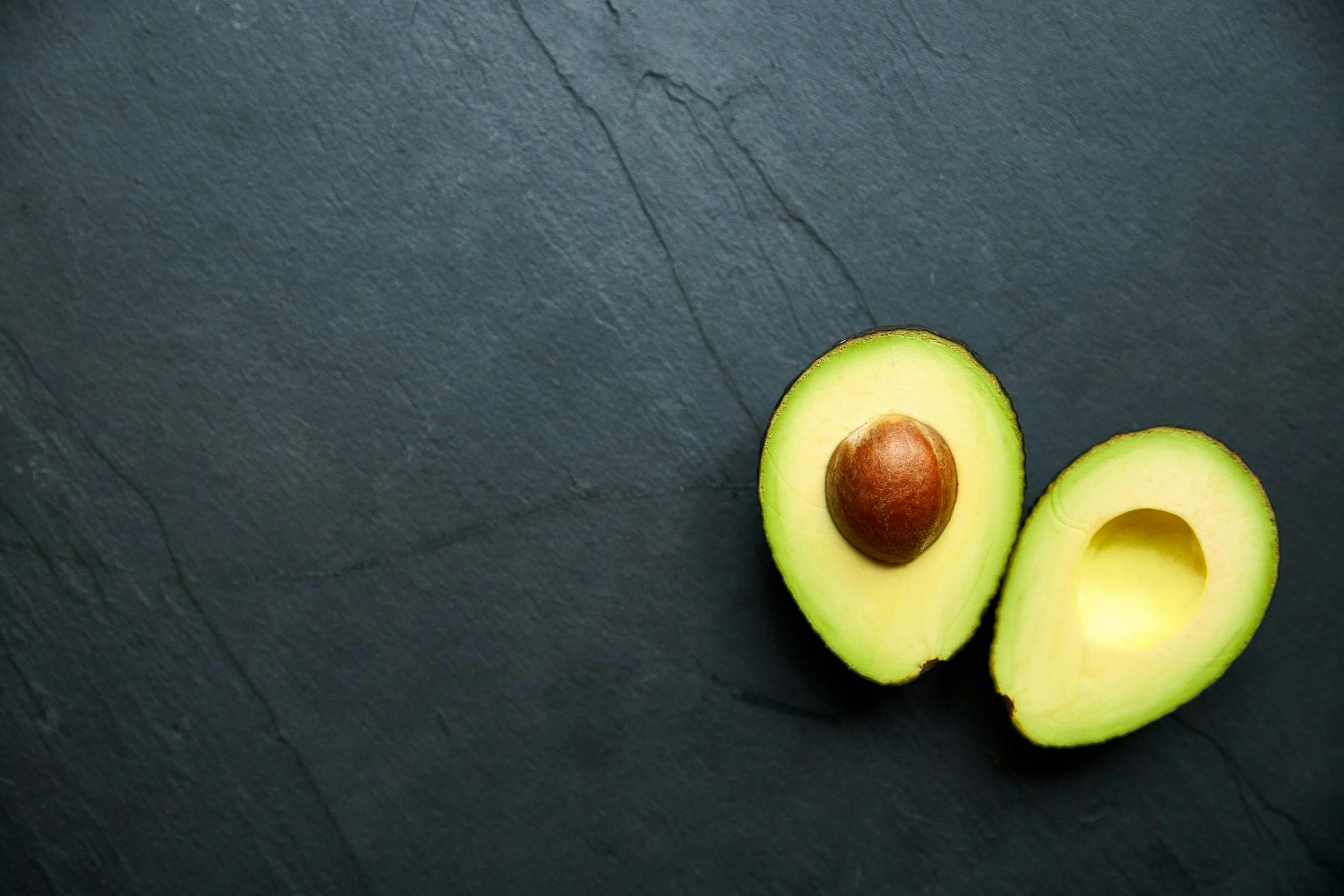 A photo with an avocado cut in half.