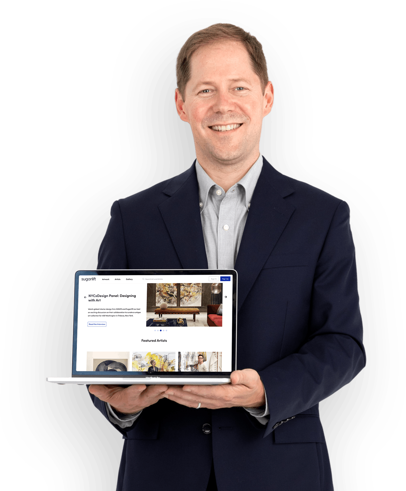Sugarlift founder Wright smiling, holding a laptop facing the camera. The laptop is open on the Sugarlift landing page.