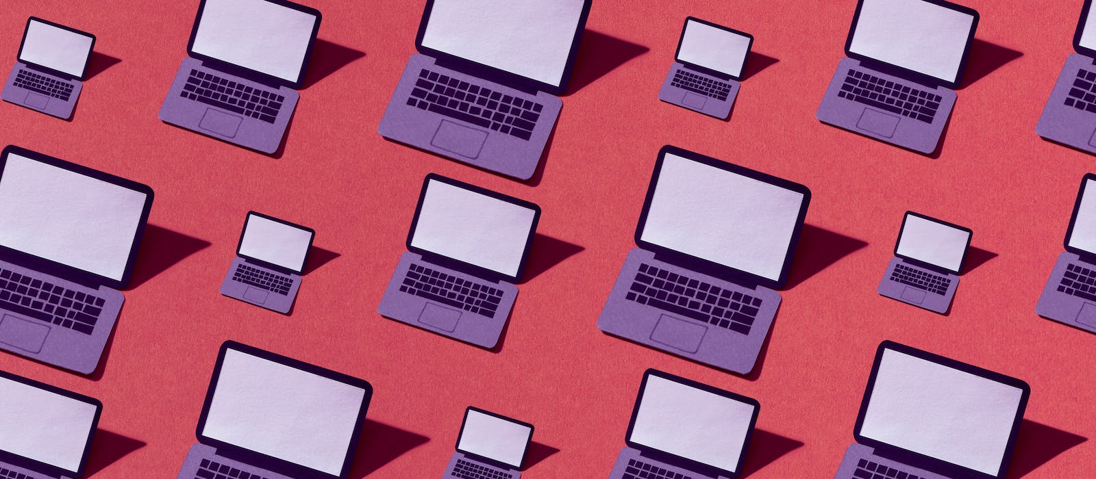 Many drawings of an open, purple laptop with a blank screen on a red background. The laptops are in different sizes and cast shadows to left.