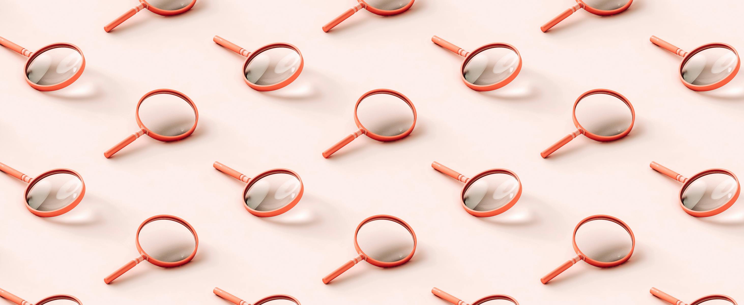 3D pattern of pink magnifying glasses on light pink background.