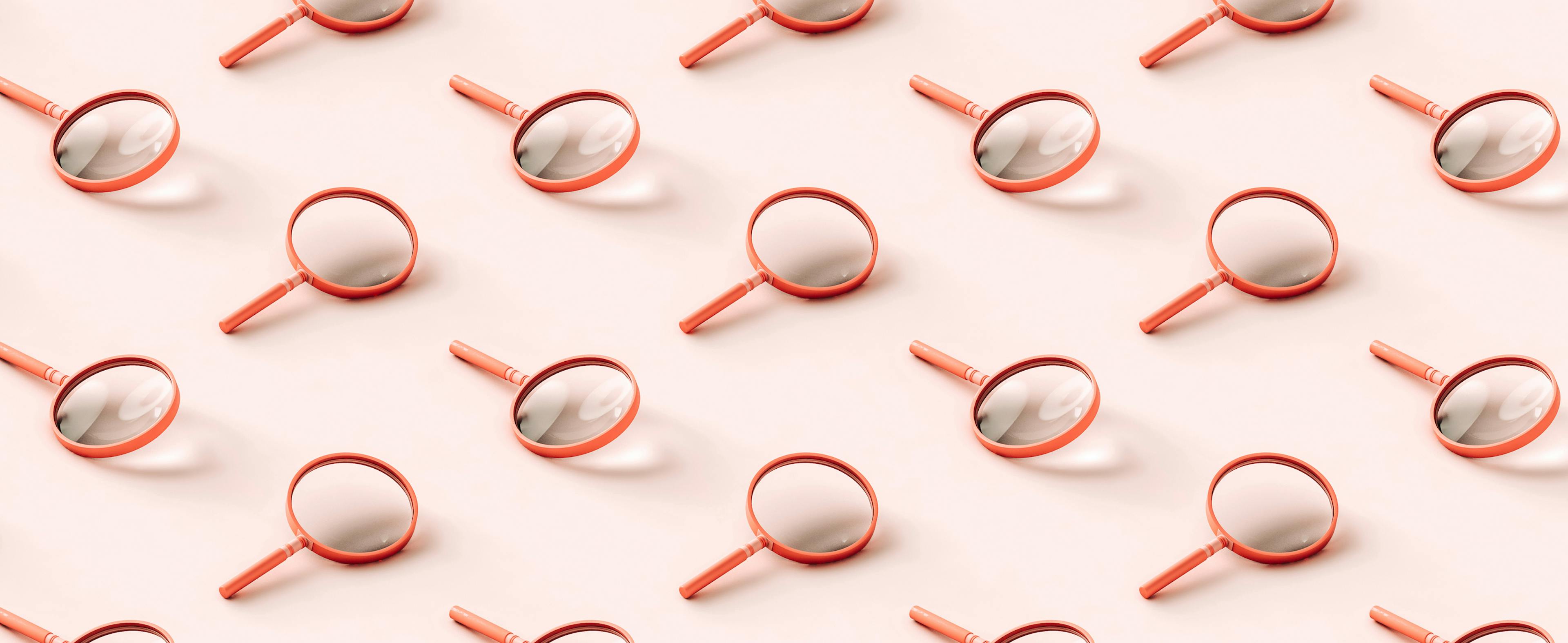 3D pattern of pink magnifying glasses on light pink background.