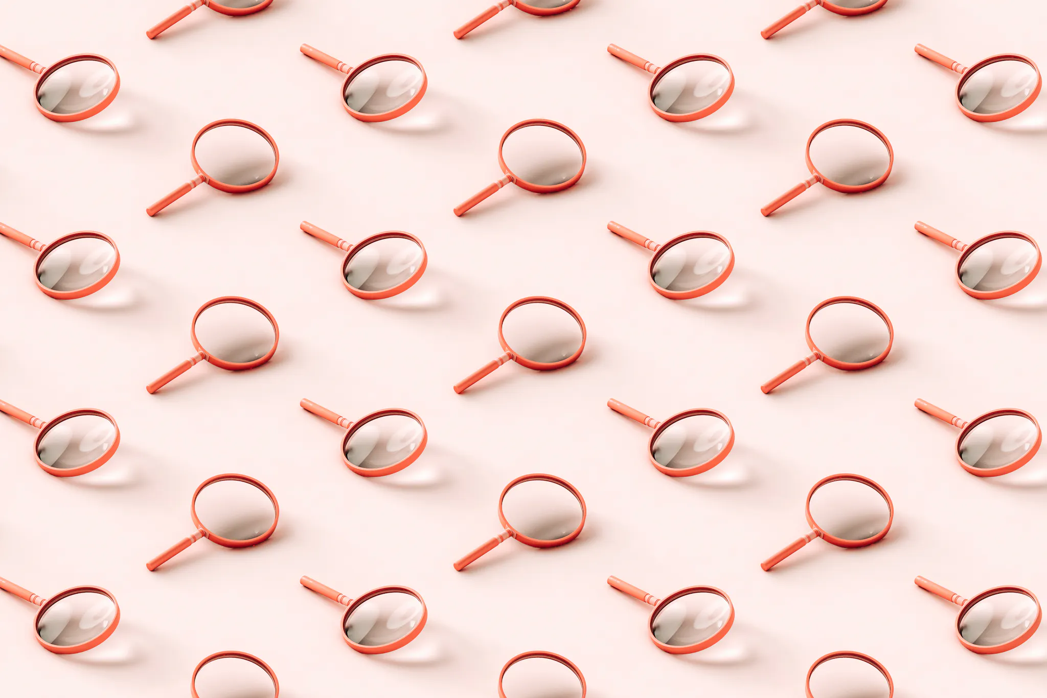 3D pattern of pink magnifying glasses on light pink background.