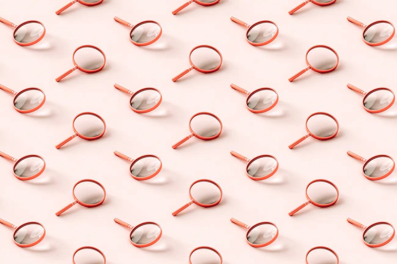 3D pattern of pink magnifying glasses on light pink background.