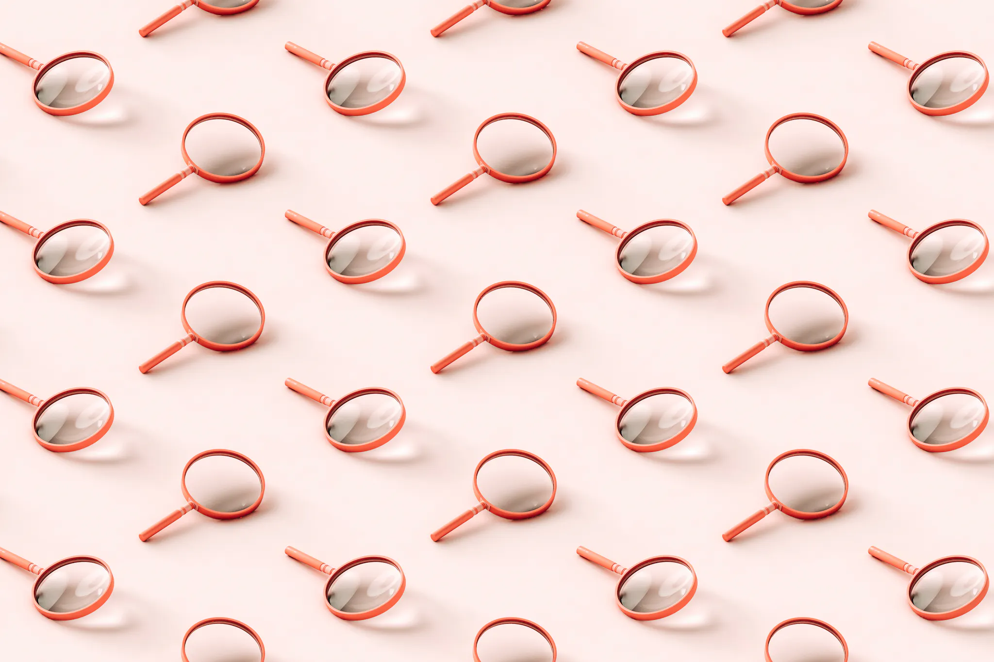 3D pattern of pink magnifying glasses on light pink background.