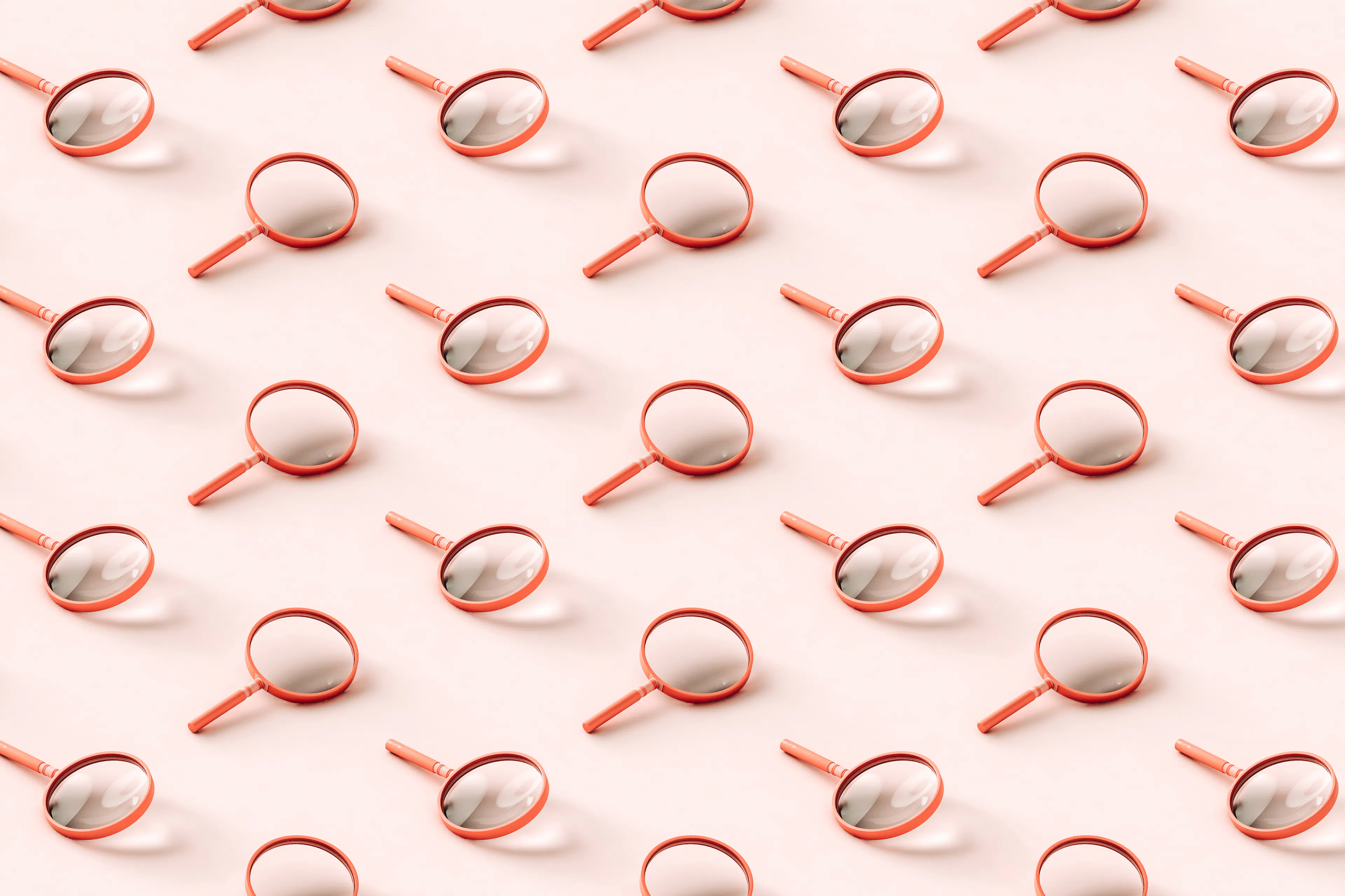 3D pattern of pink magnifying glasses on light pink background.