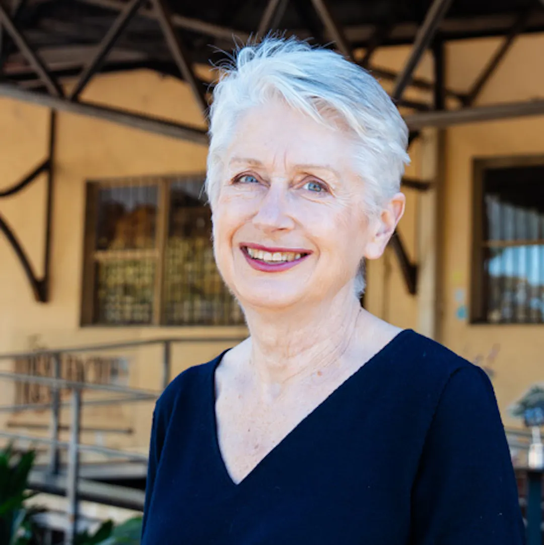 A portrait of Suzanne Campbell of Vennu, wearing a black top in front of a venue.