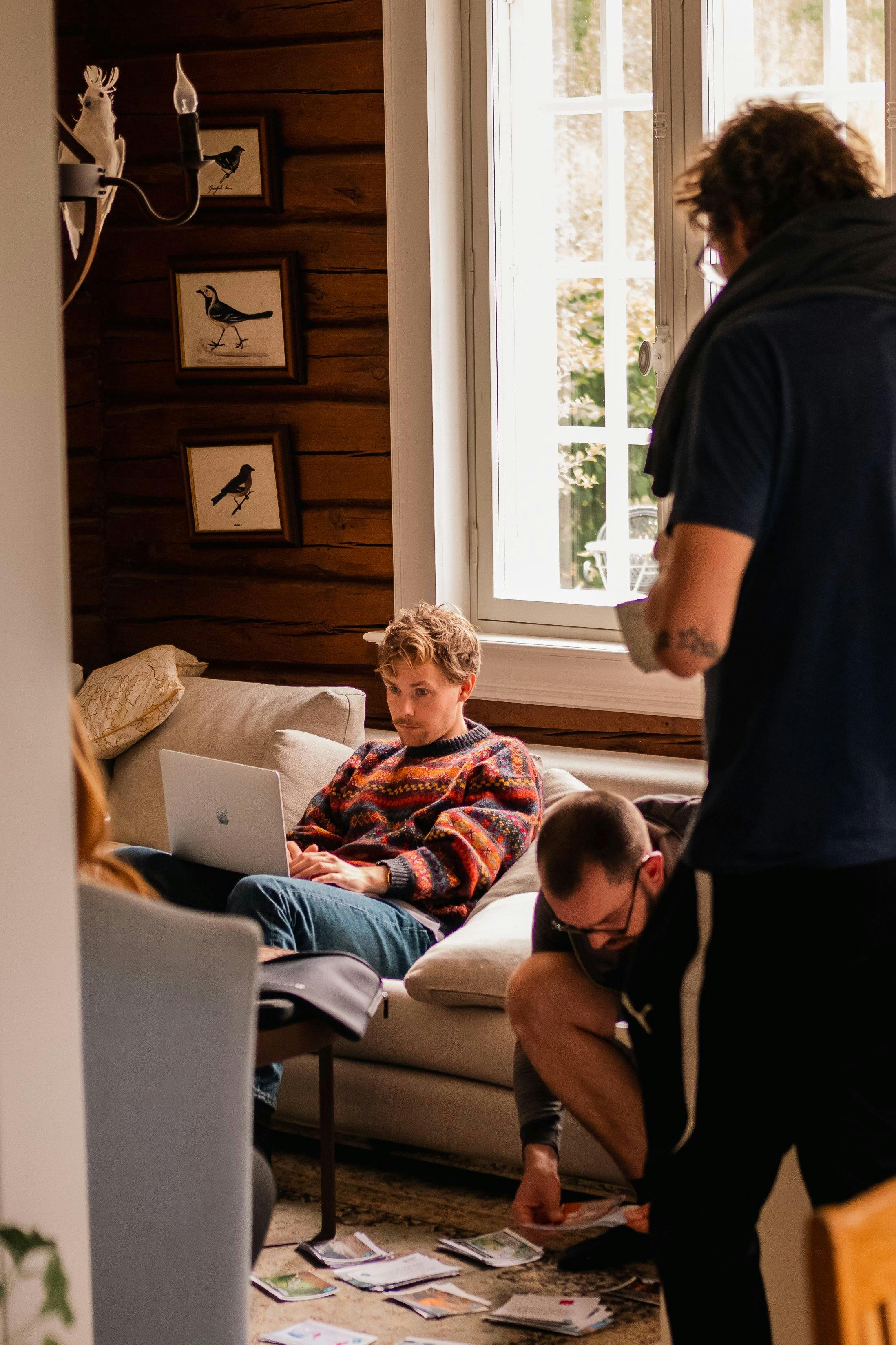 Indoor scene with two people working in a rustic, cozy room.