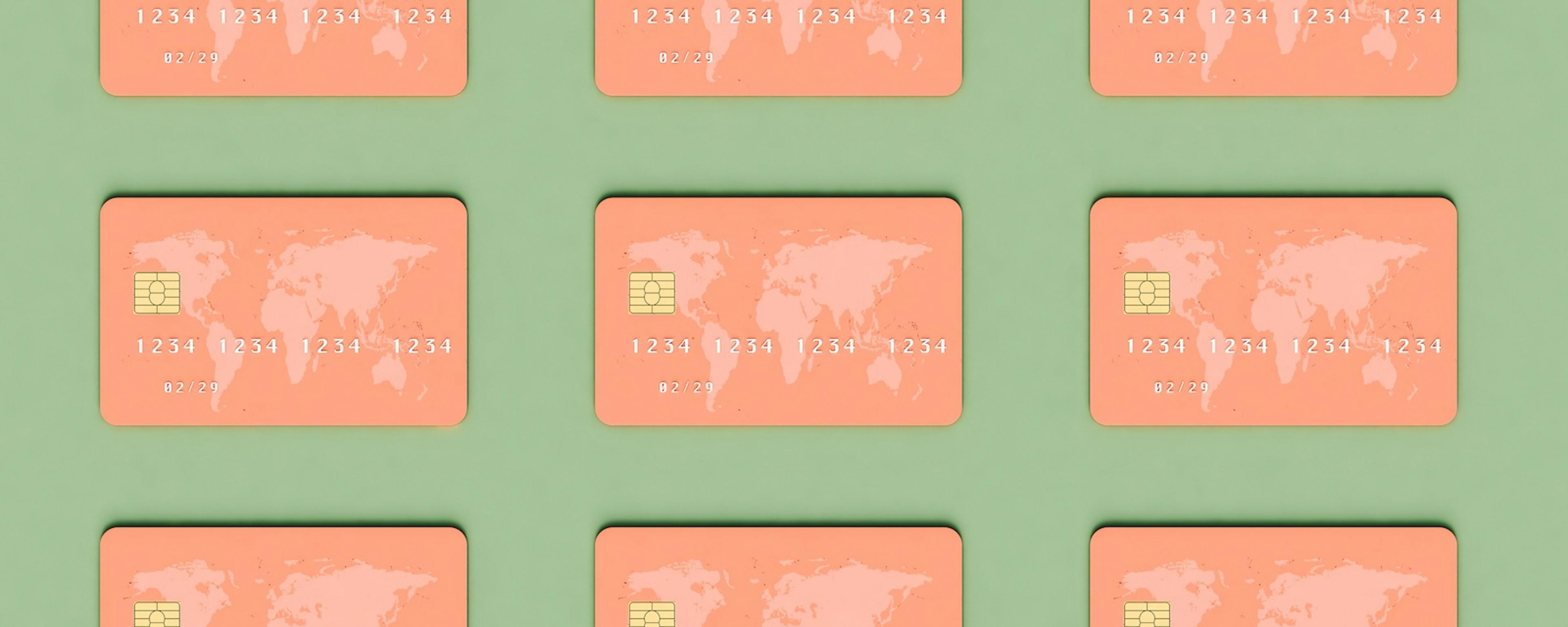 Nine orange credit cards with the picture of the world map arranged in a symmetrical grid against a light green background.