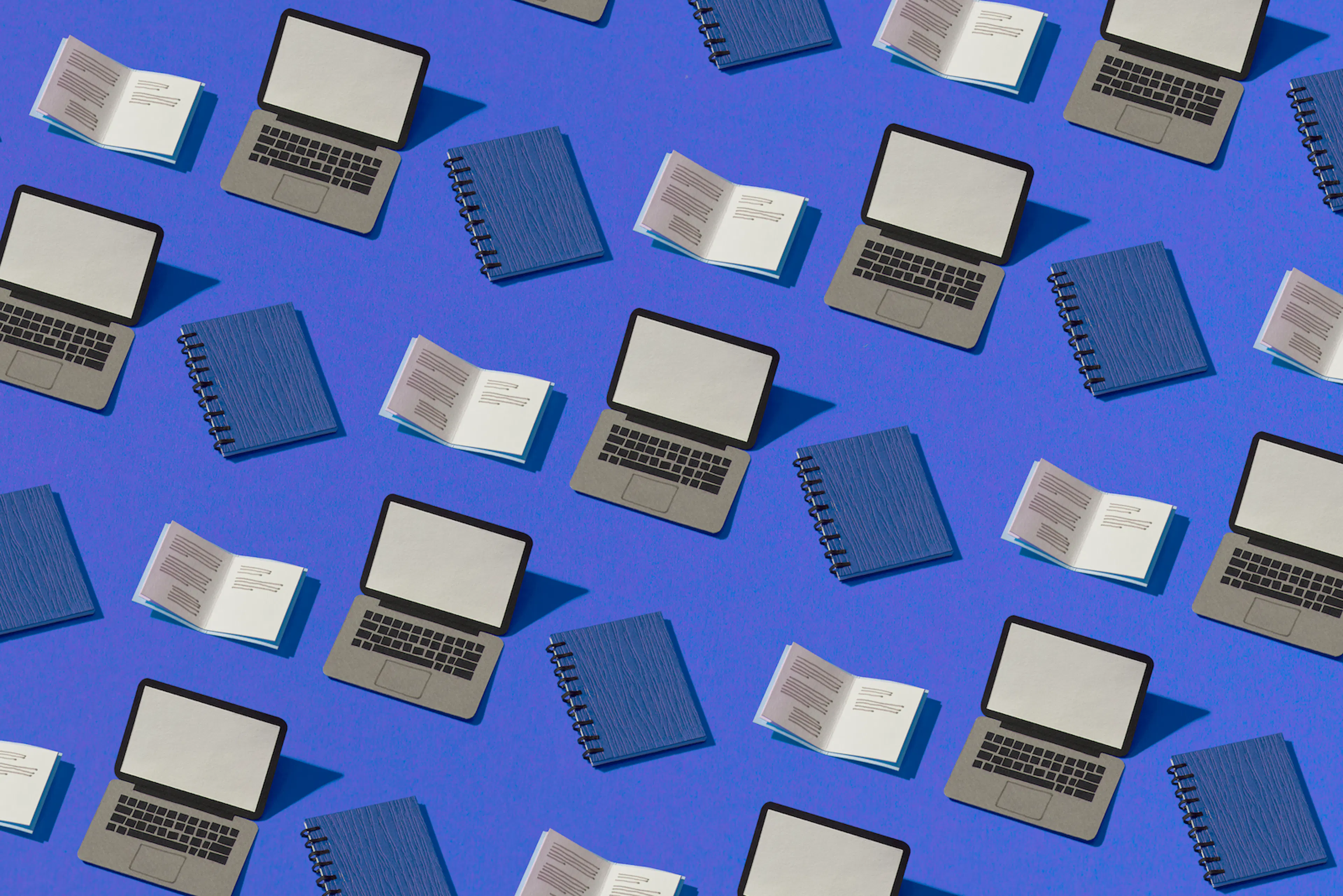Multiple drawings of a open grey laptop, closed blue notebooks and open notebooks with black lines simulating text, interspersed on a blue background.
