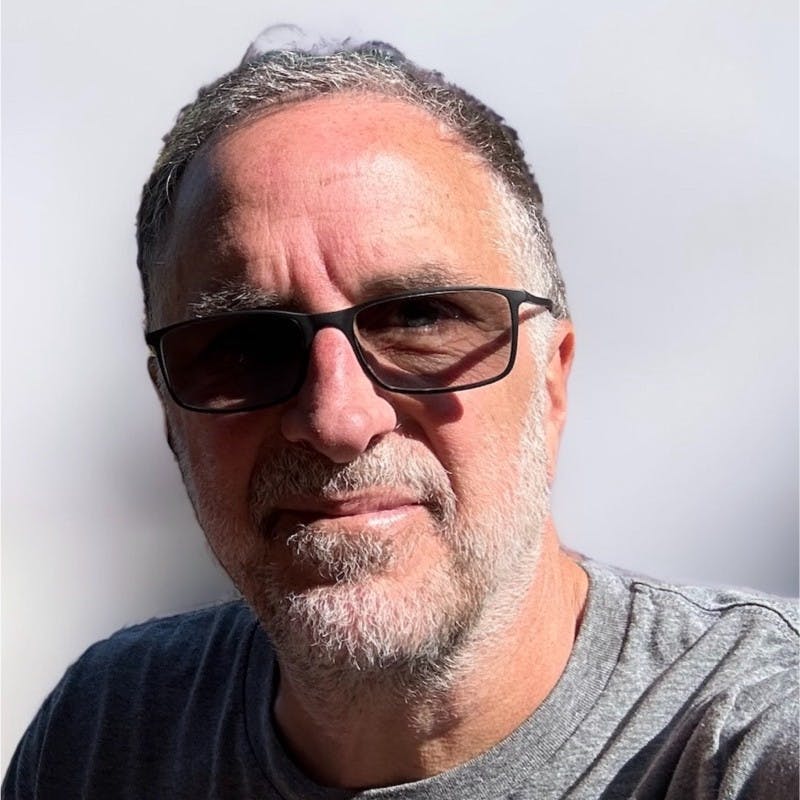 Headshot of Gearsource founder Marcel Fairbairn wearing sunglasses and a gray t-shirt.