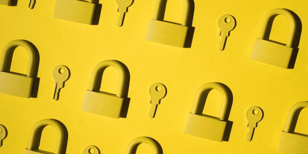 Yellow locks and keys against a yellow background.