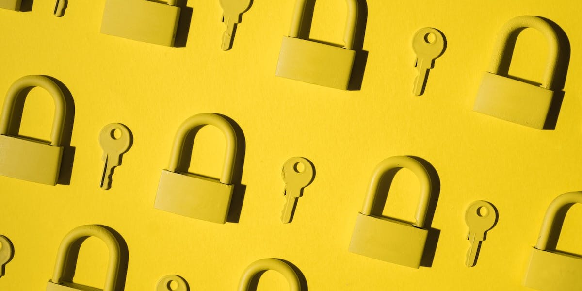 Yellow locks and keys against a yellow background.