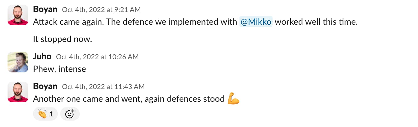 Slack messages from Boyan reporting that new attacks have come and our defences have blocked them, with Juho commenting "Phew, intense".