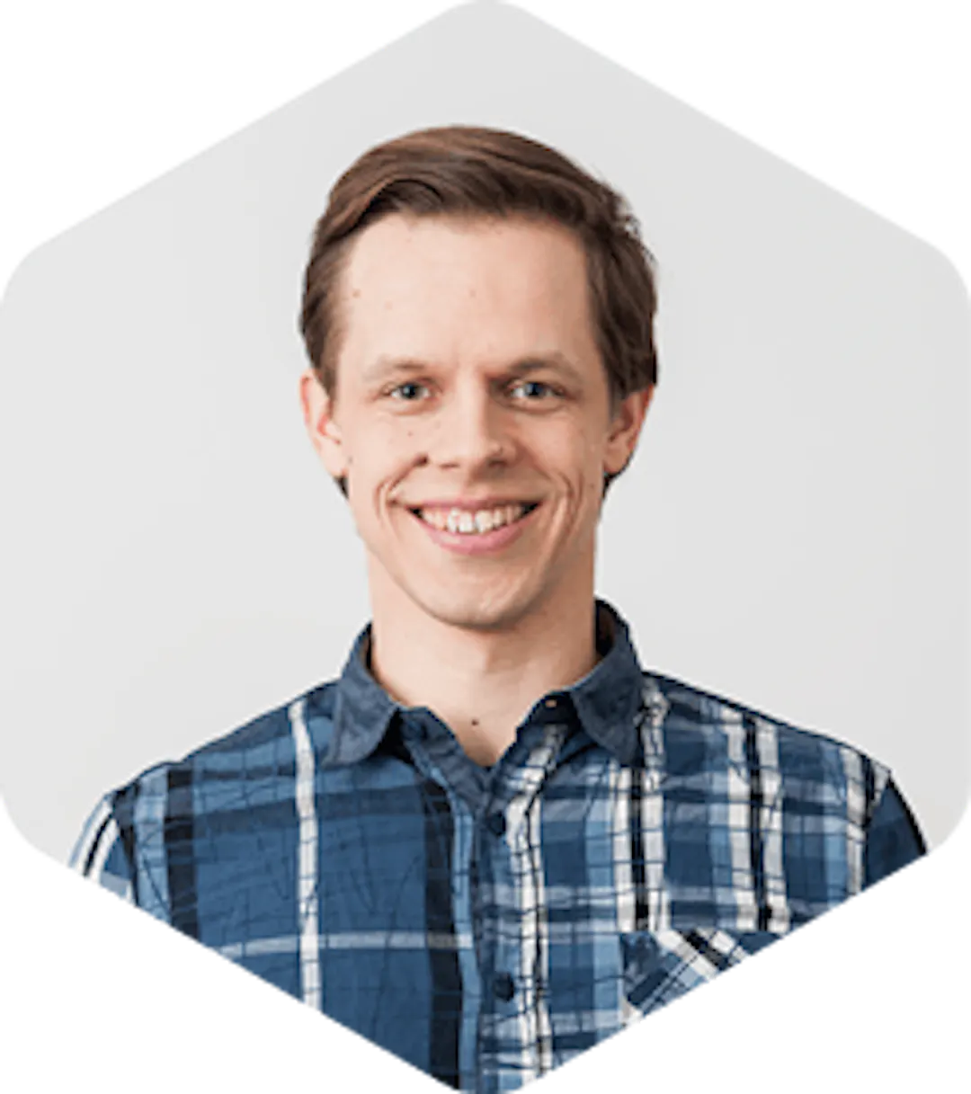A headshot of Antti on a white background, smiling with the open mouth.