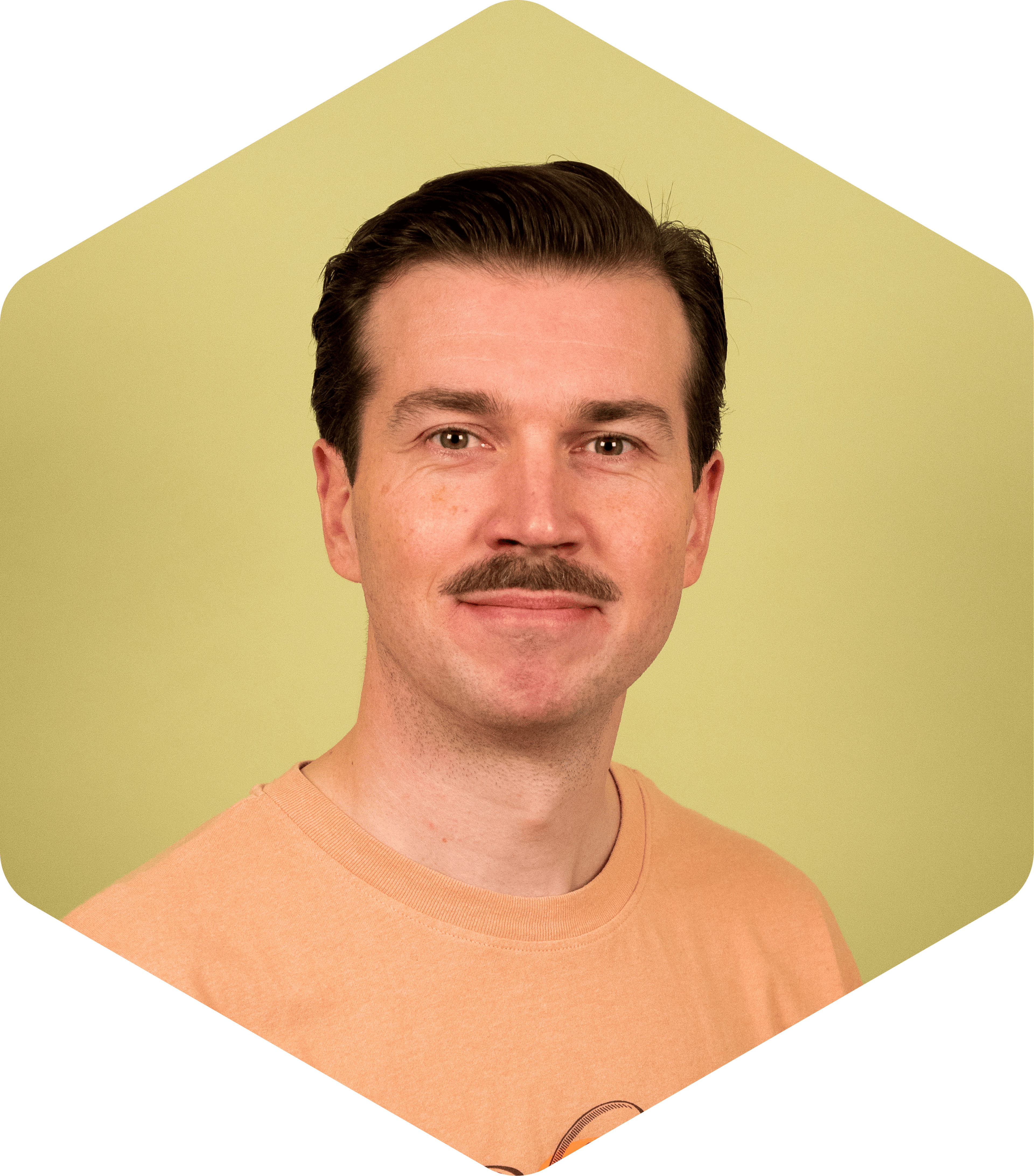 Hannu wearing an orange T-shirt, facing the camera on a light green background.