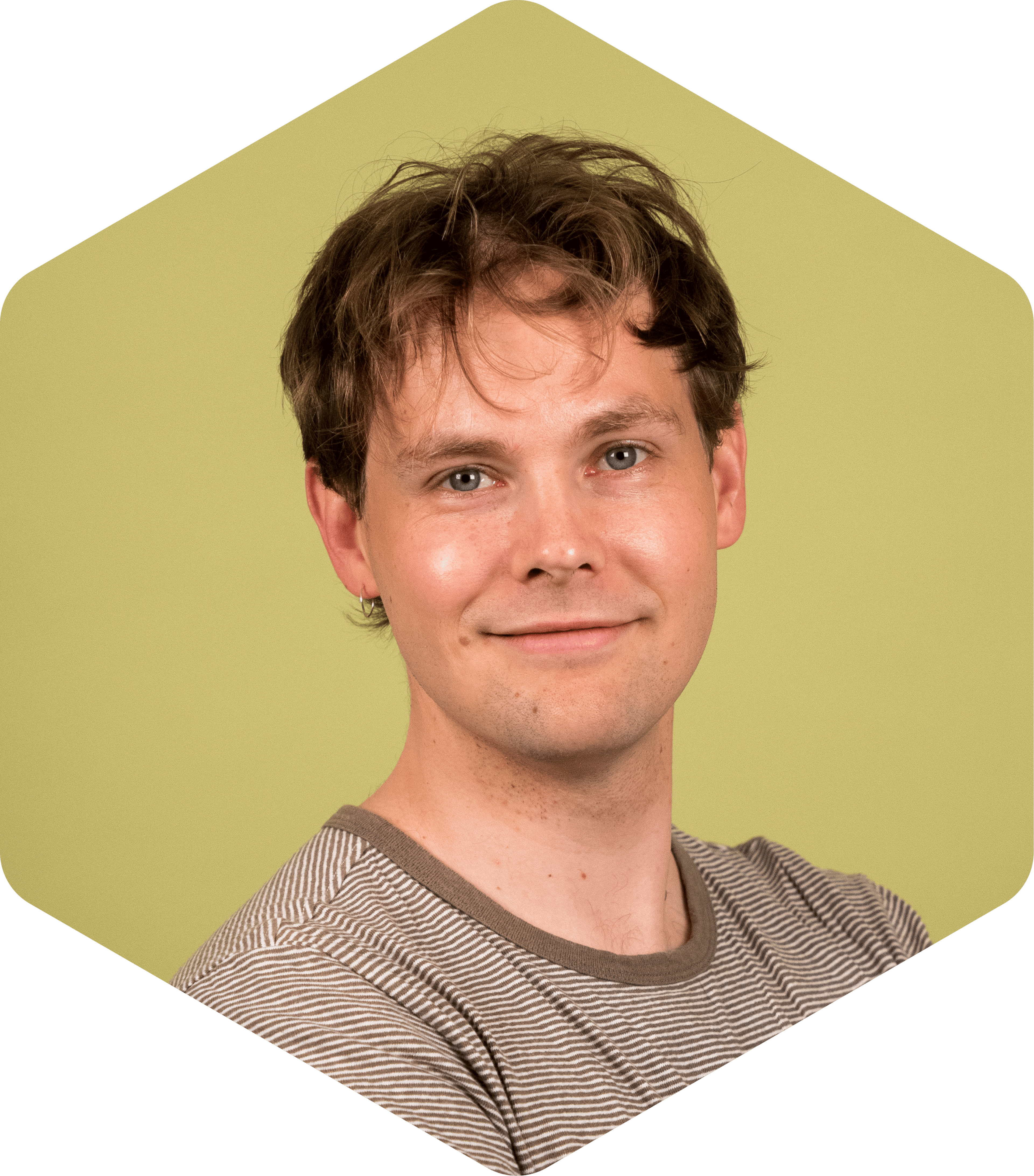 Aleksi smiling, wearing a striped shirt, against a light green background.